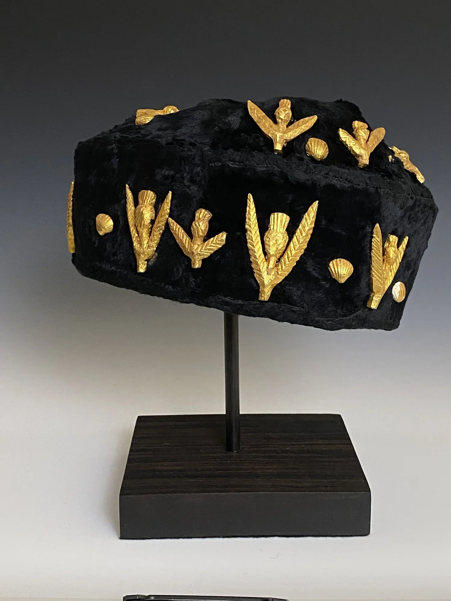 A coastal Akan chief’s crown, Shama region, Ghana. (fabric, wood covered with hammered gold foil, seashells covered with hammered gold foil.) The Akan chief’s head gear regalia, commonly referred to as crowns, are worn by chief regents during ceremon
