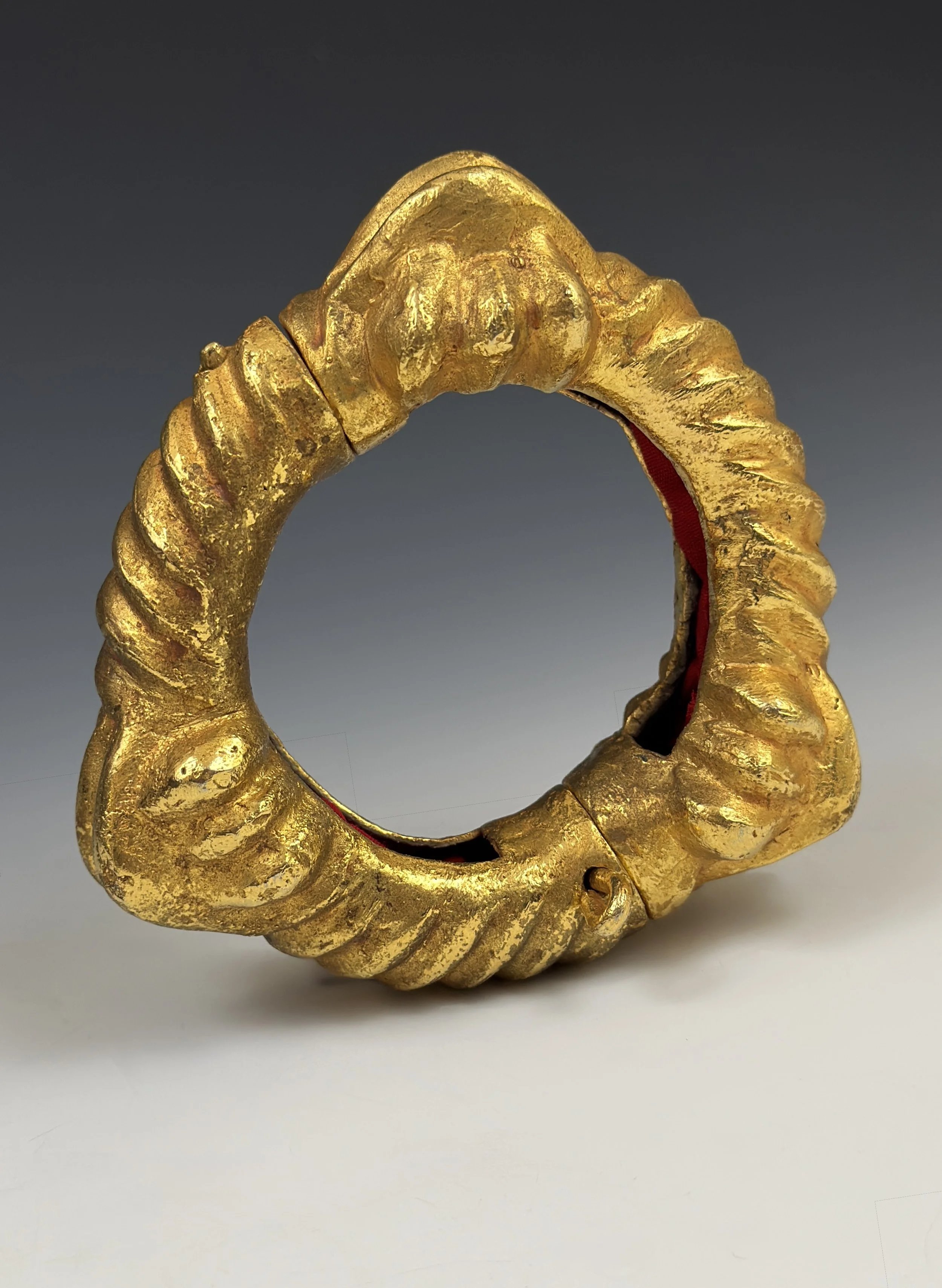 A large Asante hinged bracelet, cast alloy with a heavier gold gilding on the outside surface. The alloy is most likely copper with other trace metals such as gold and silver but a proper analysis must be made to confirm. Exterior diameter 4 1/2” (1