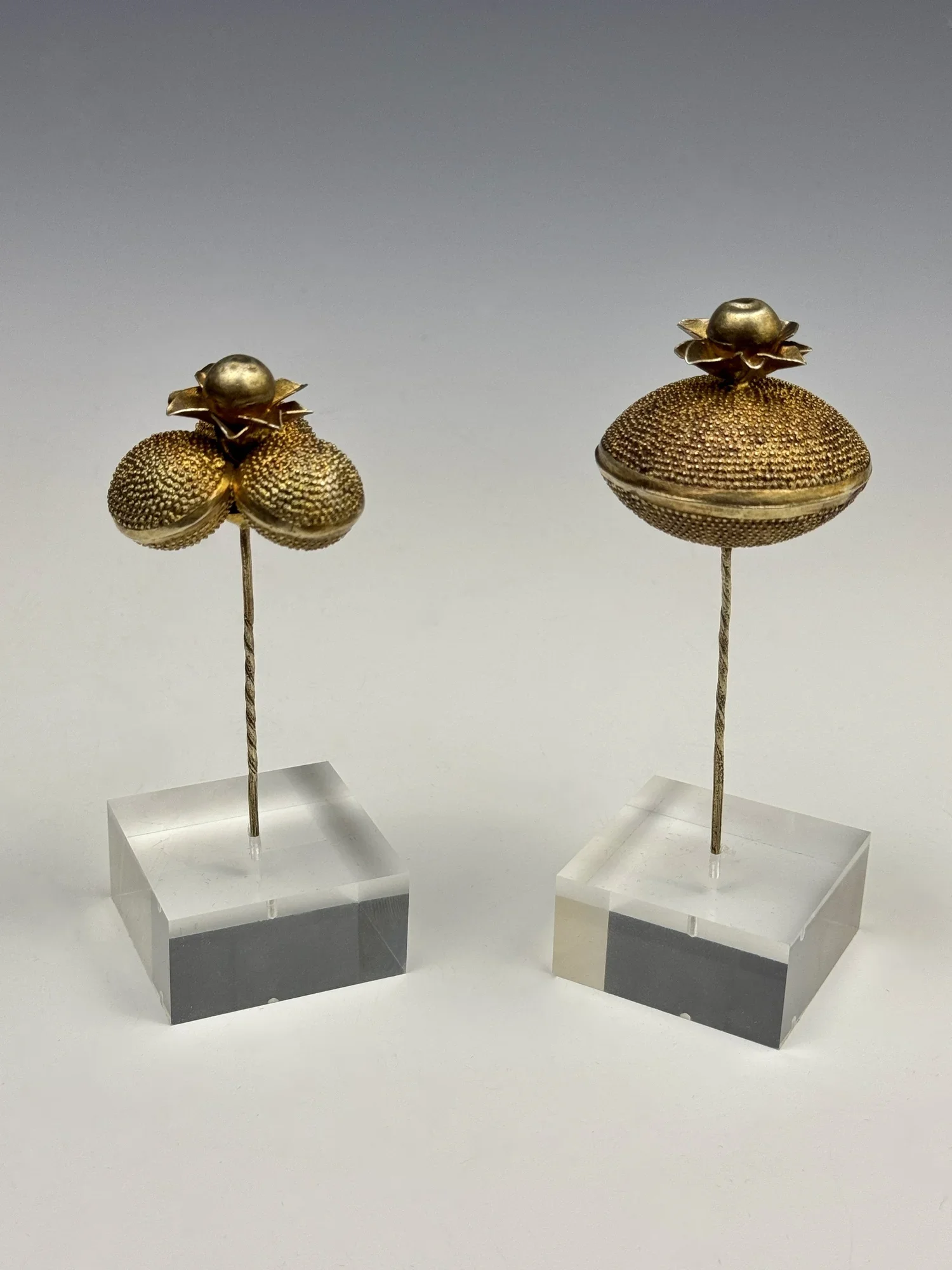 Two Akan (Fante) fabricated gilt silver/silver-gold alloy hairpins with a floral pattern (Victorian style), 2” dia, Ghana. “Many Victorian motifs and patterns are still being reproduced in contemporary versions. The continuing interest in this design