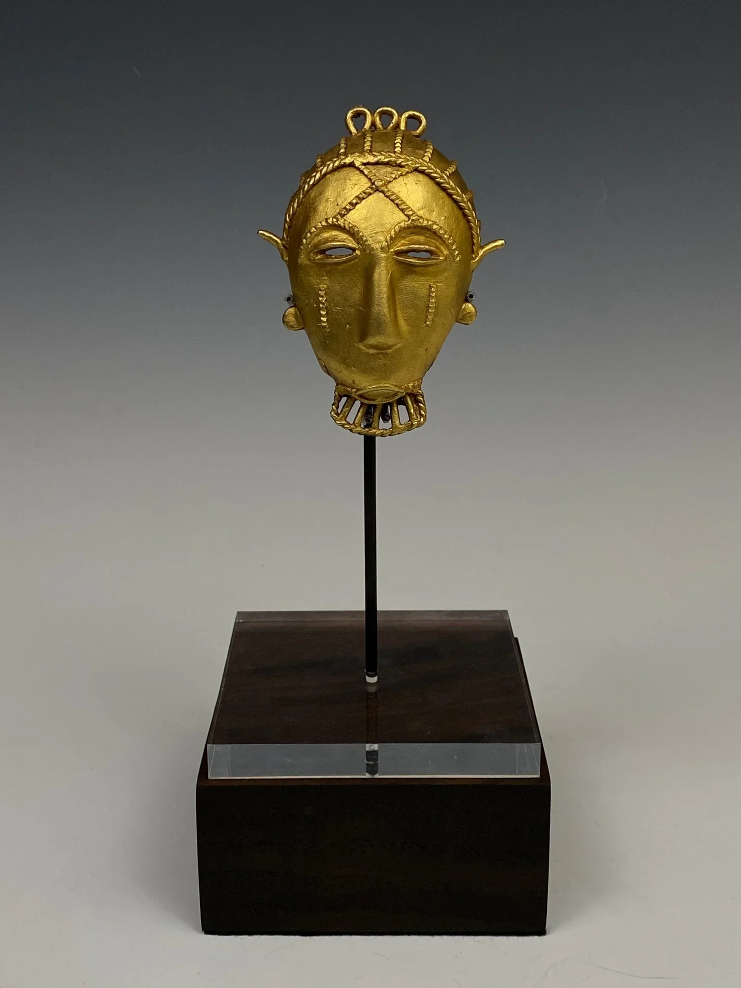 Akan cast gold pendant mask, Côte D’Ivoire/Ghana 9.70cm. From the estate of Olga Hirshhorn