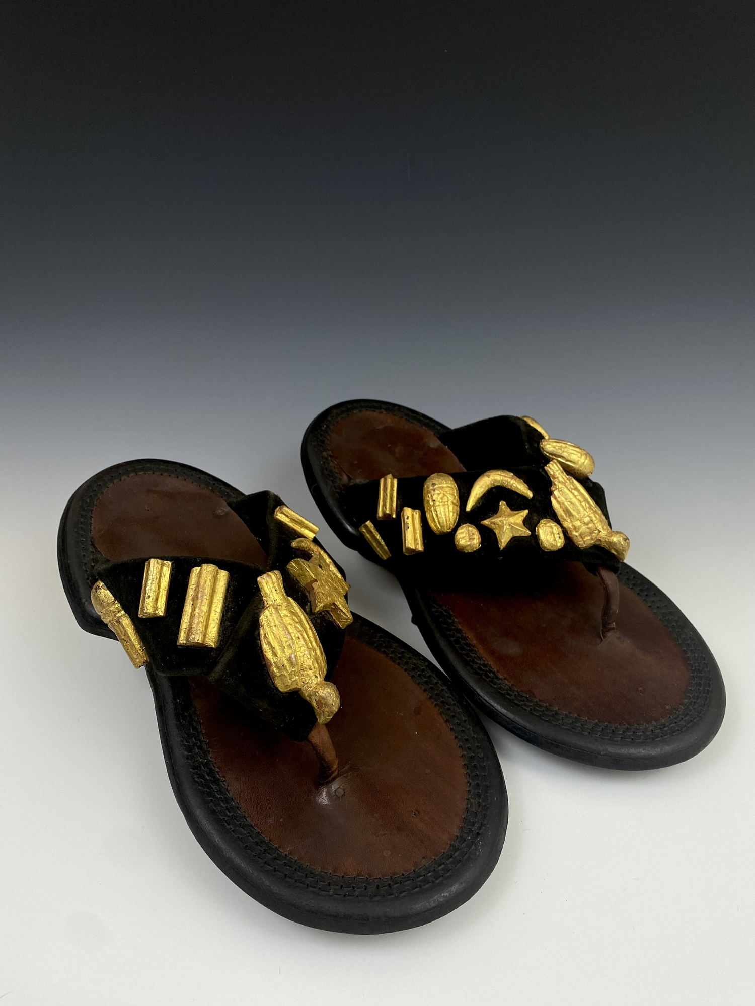 Chief sandals (mpaboa), leather, wood covered with gold foil. Ghana. Sandals are the equivalent to the European crown when identifying a ruler in the Akan states. The straps are usually covered with gold ornaments that point to proverbs and can also