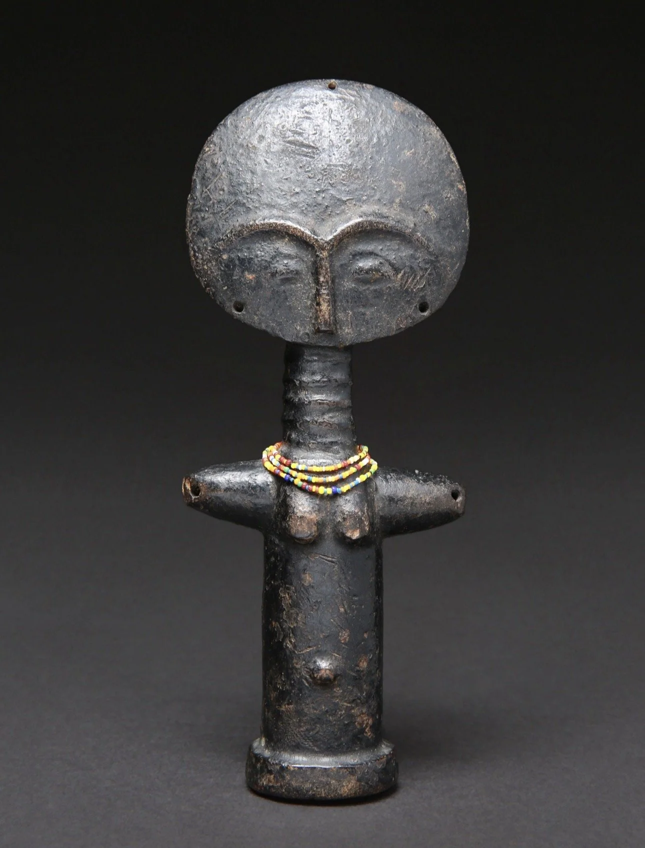 A small Asante "Akua-ba" figure with a much larger presence, Ghana. Wood, glass beads. H 17 cm. W 7 cm.
Provenance: 
- Timothy F. Garrard (1943-2007)
- Christie's Paris, France. December 6, 2005,    Lot 127.
- Private collection, Western Switzerland.