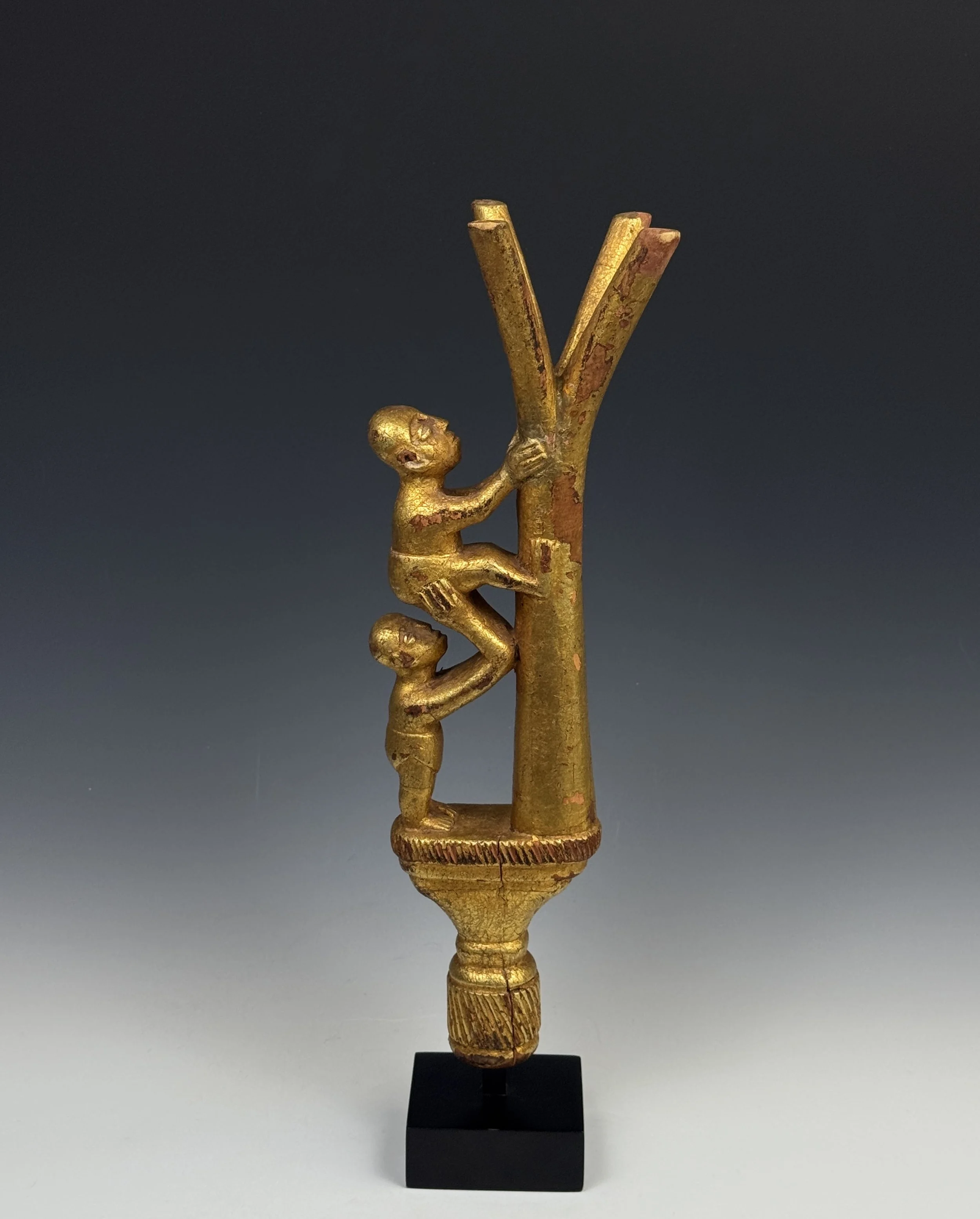 An Ashanti linguist staff finial (okyeame poma). Ghana. The finial depicts a tree with one figure helping another to climb it. Ht. 16 in. It depicts the saying, "If you climb a good tree, you get a push," or if your intentions are good, people will h
