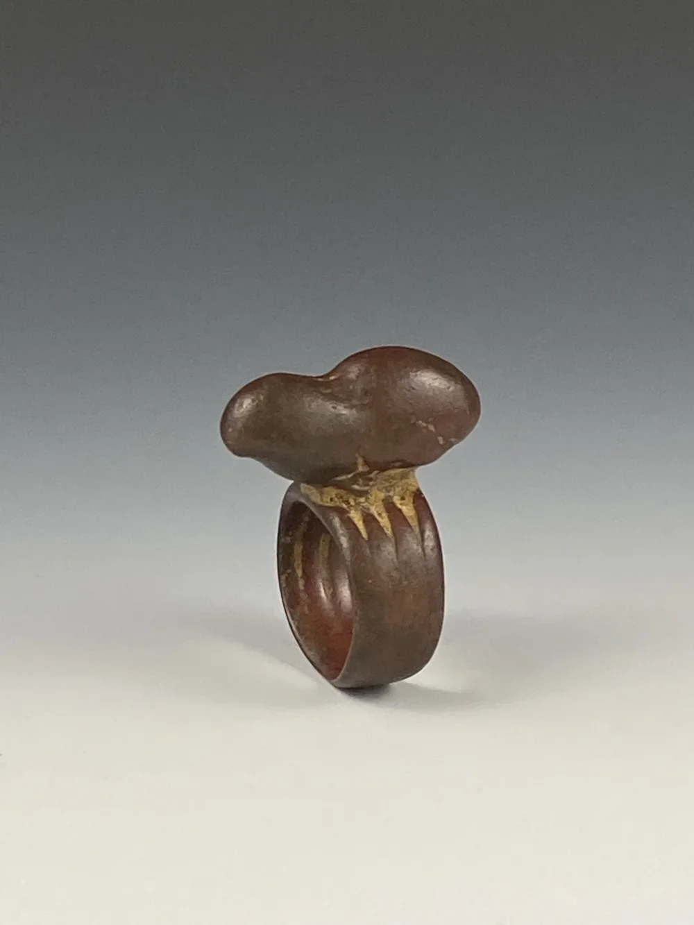 Dogon? Senufo? Akan? A bronze ring with a gorgeous patina. Collected in the Dogon village of Pomorodoudiou, Mali. I believe the image is of a peanut. It was possibly worn to promote a good harvest. Items travel through markets throughout Africa so it