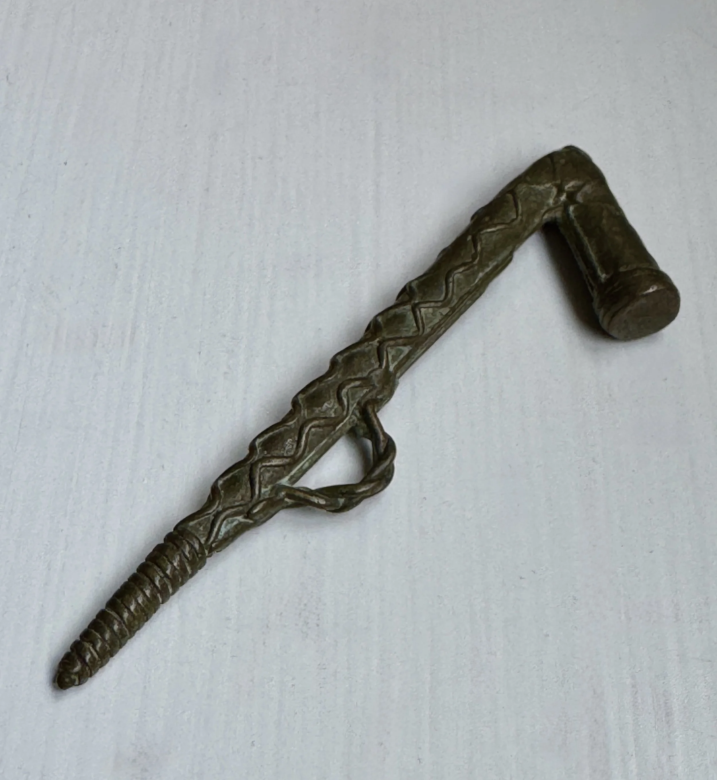 A copper alloy gold weight depicting a drum stick. Asante, Ghana. Ex Private Washington DC collection, ex London auction house.