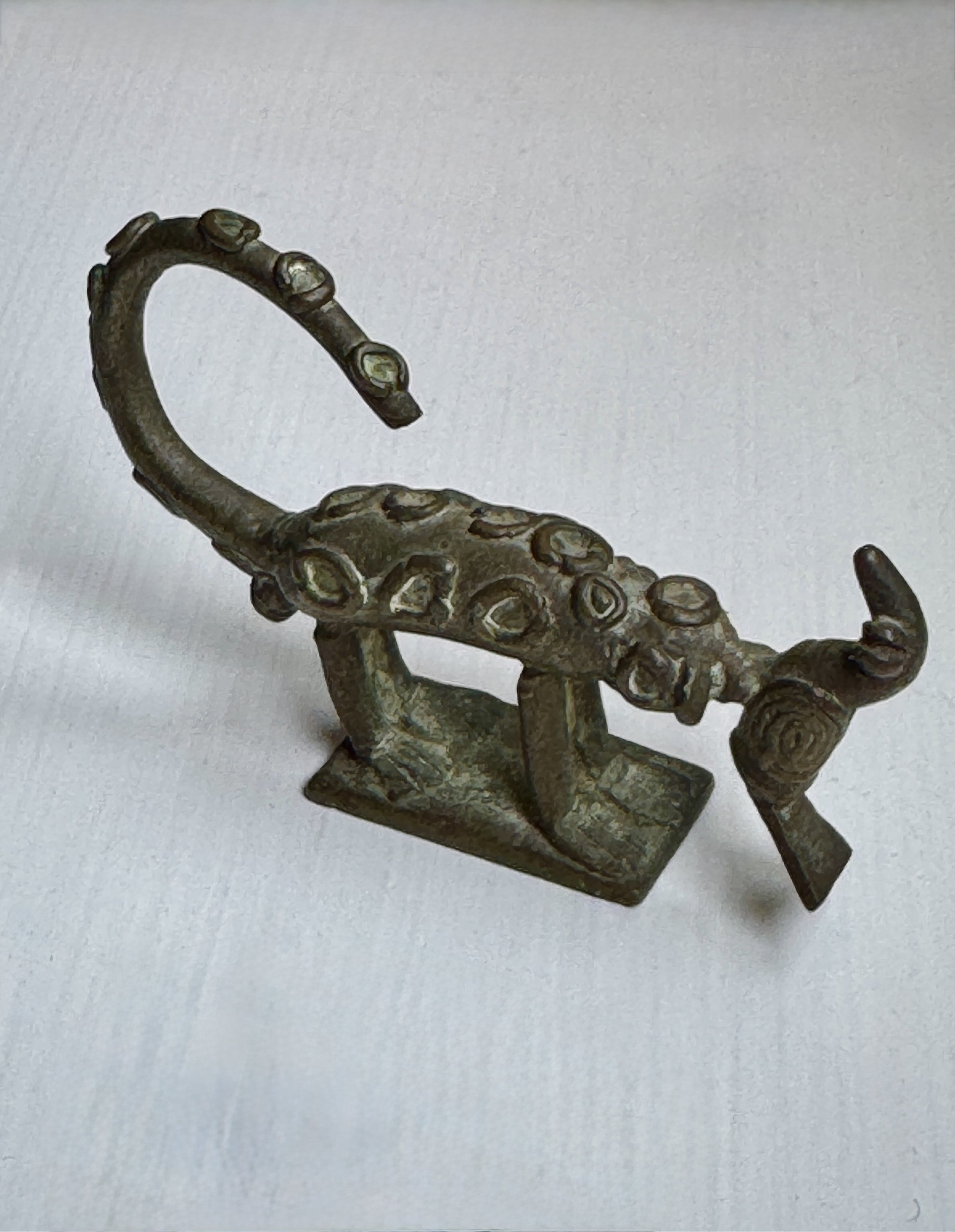 A copper alloy gold weight depicting a leopard capturing a bird. Asante, Ghana. Ex Washington DC collection, Ex London collection.