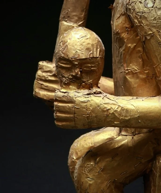 The severed head in this example is displayed proudly in the figure's left hand while the sword is held triumphantly in the right.