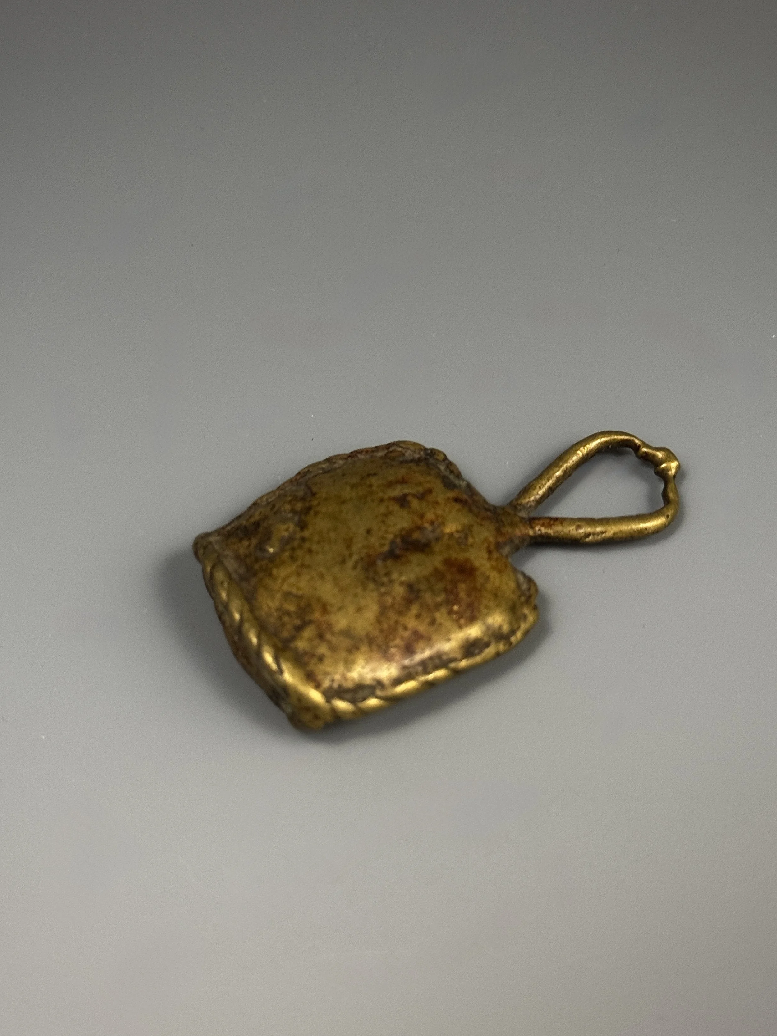 Akan copper alloy gold weight in the form of a leather protective/ power amulet. Ex Vérité collection, France. Pierre Vérité (1900-1993) began collecting in the 1920s, at the dawn of French art market and a time when someone with a knowledgeable eye 
