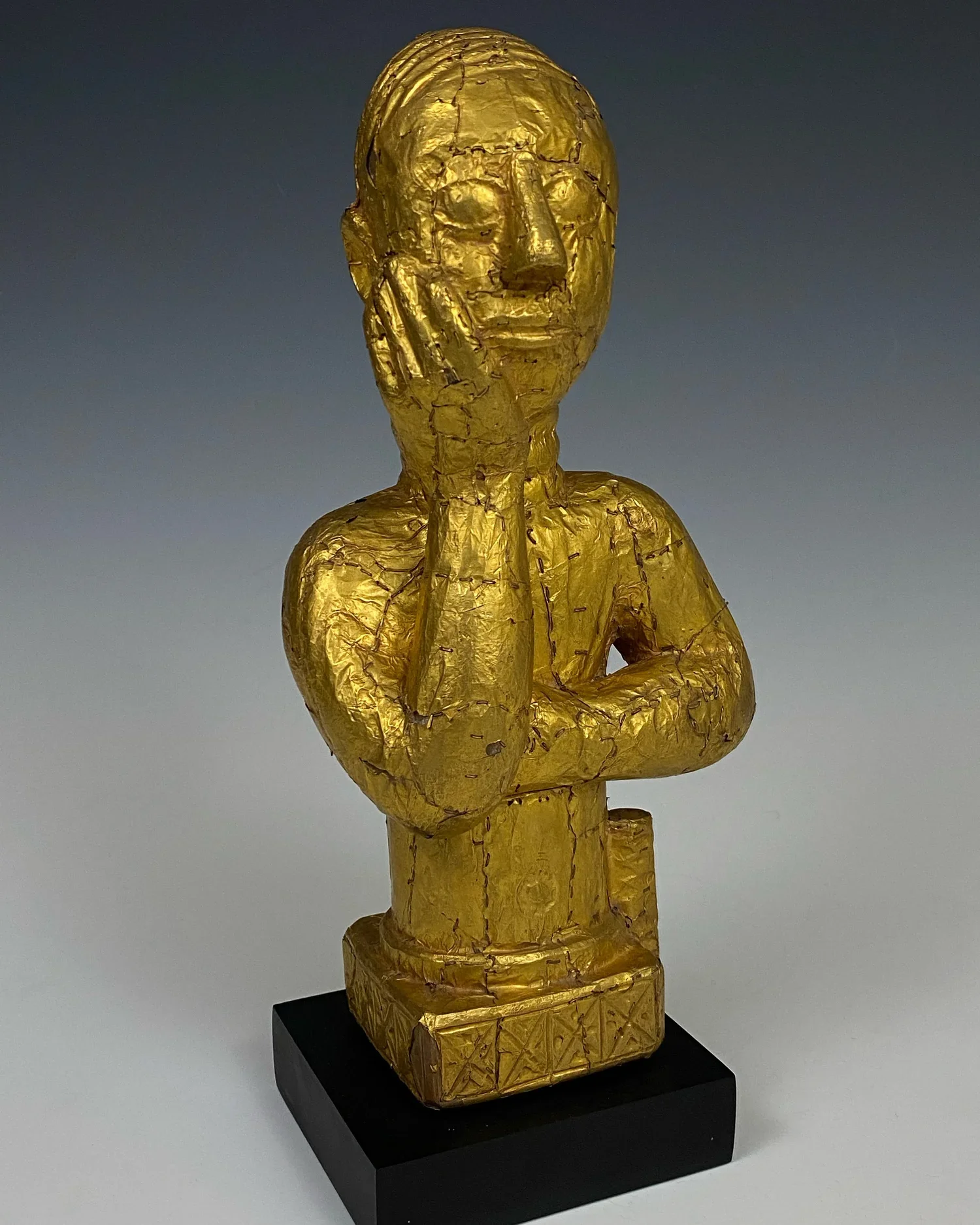 An Asante (Okyeame Poma) linguist staff finial. Wood, hammered gold foil and gold staples. The hammered gold sheet has been attached to the carved wood with gold staples. 9 1/2" x 4 1/2" x 3 1/2", c. 19th- 20th century (1890s-1920s). “The food is for