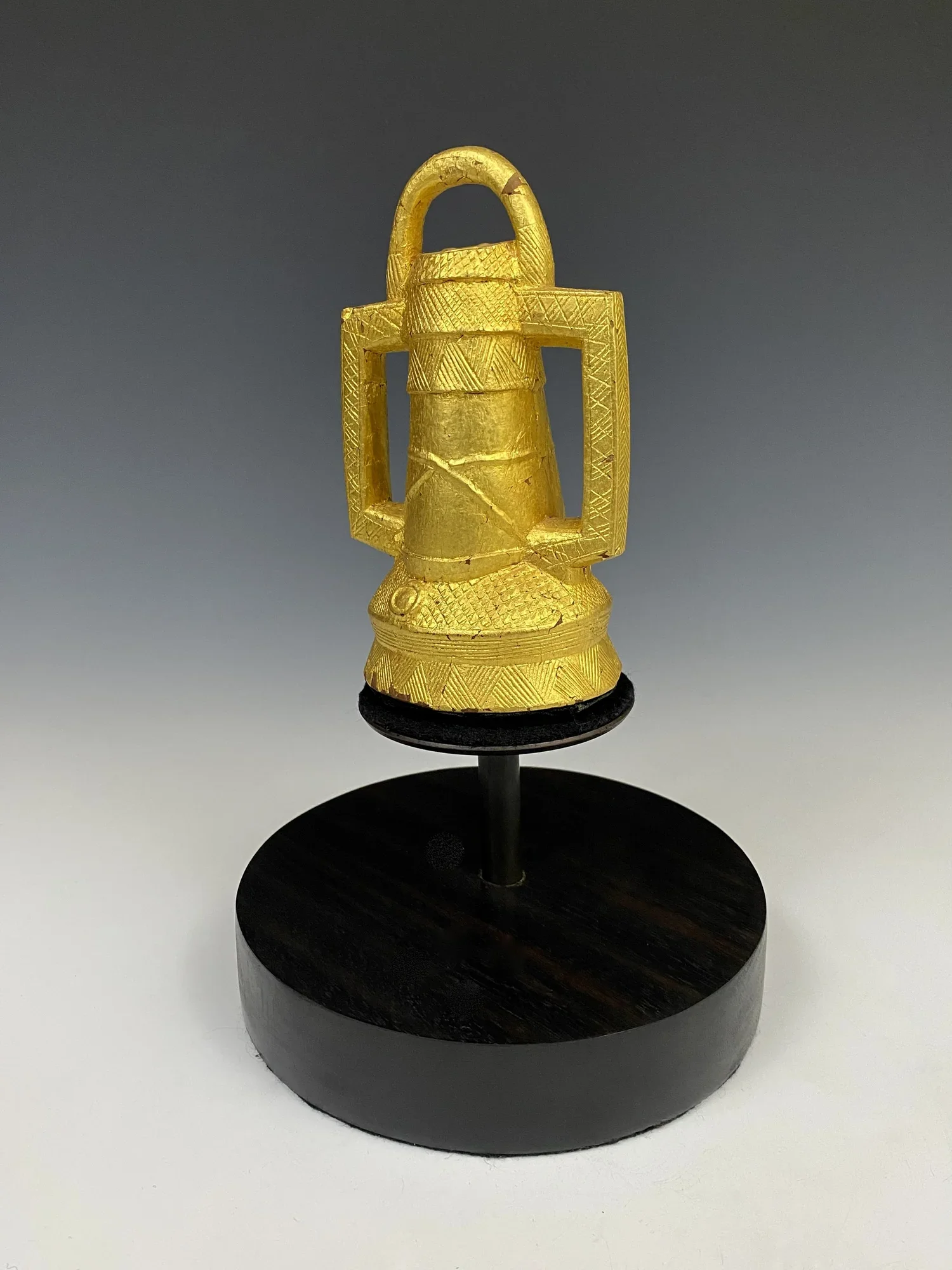 Baule (Baoulé) prestige item “Lantern”, wood covered with gold foil, Côte d’Ivoire. H 15 cm. “Within the aja the baule have an ostentatious assortment of gold-covered wood objects, many of which do not have counterparts in Akan regalia. Most are nonf