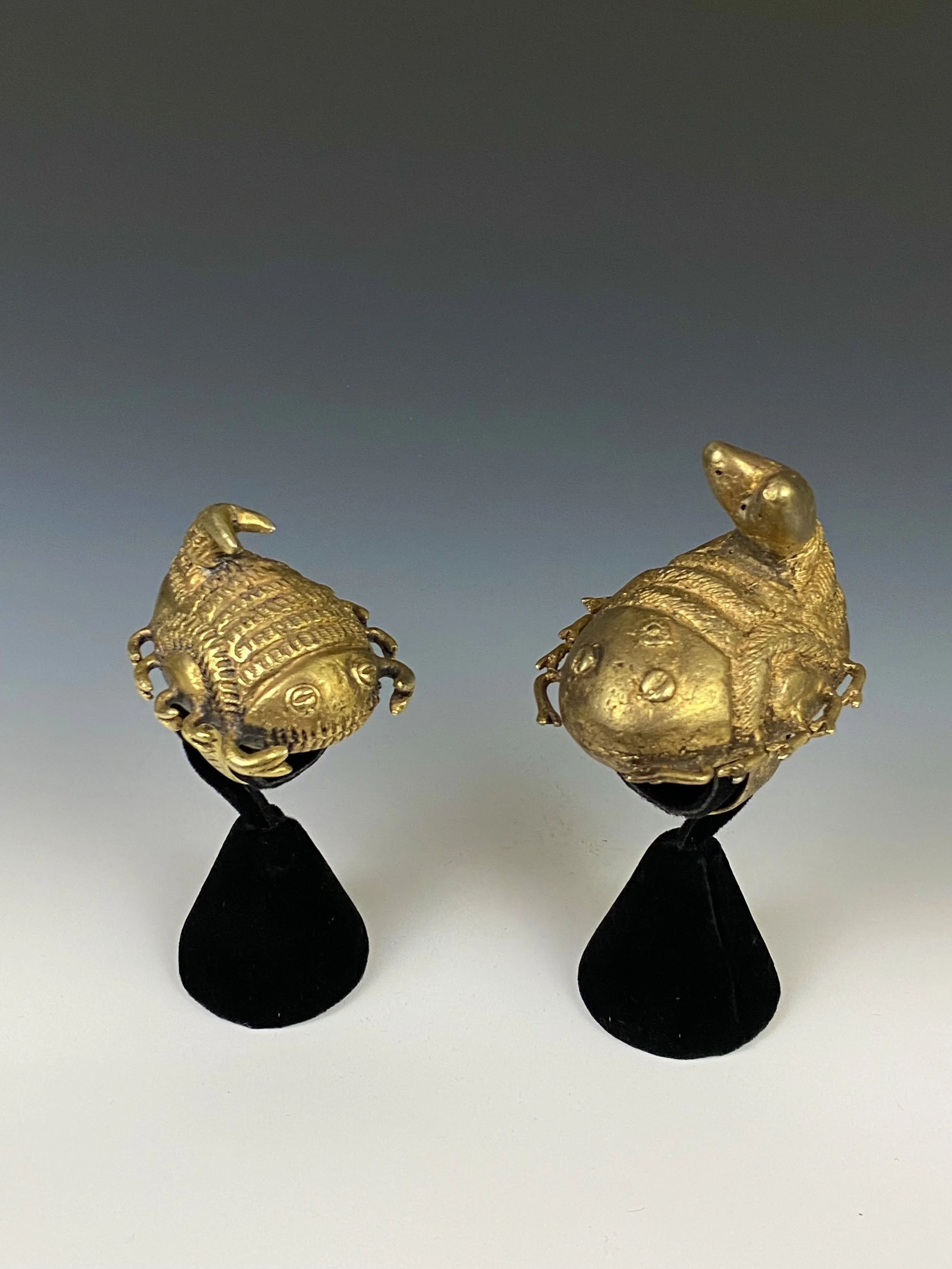 Two Asante chief rings “mpetea” in the form of two scorpions, Ghana. Cast gold/silver alloy, H 4 cm and H 5.7 cm. One proverb associated with the scorpion is “The sting of the scorpion is as slow to subside as a fire is to cool.”- if you incur the ch