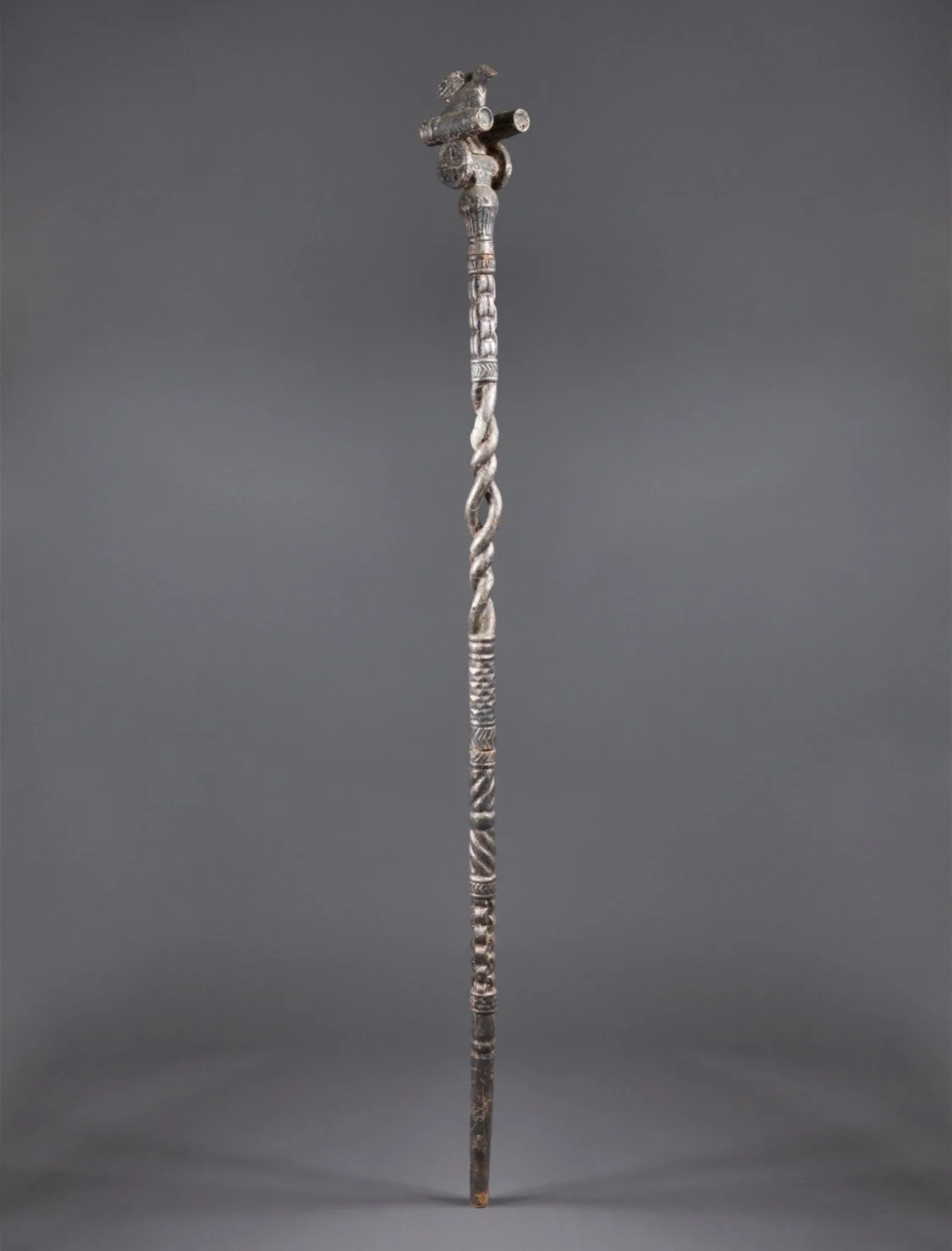 he image is the “bird that flies with cannons.” An exquisitely carved Asante “Okyeame poma” (linguist/counselor’s staff). Wood, hammered silver foil. Ghana. 62.5 inches H. Magnificent gold-covered staffs (or in this case silver covered) are carried b
