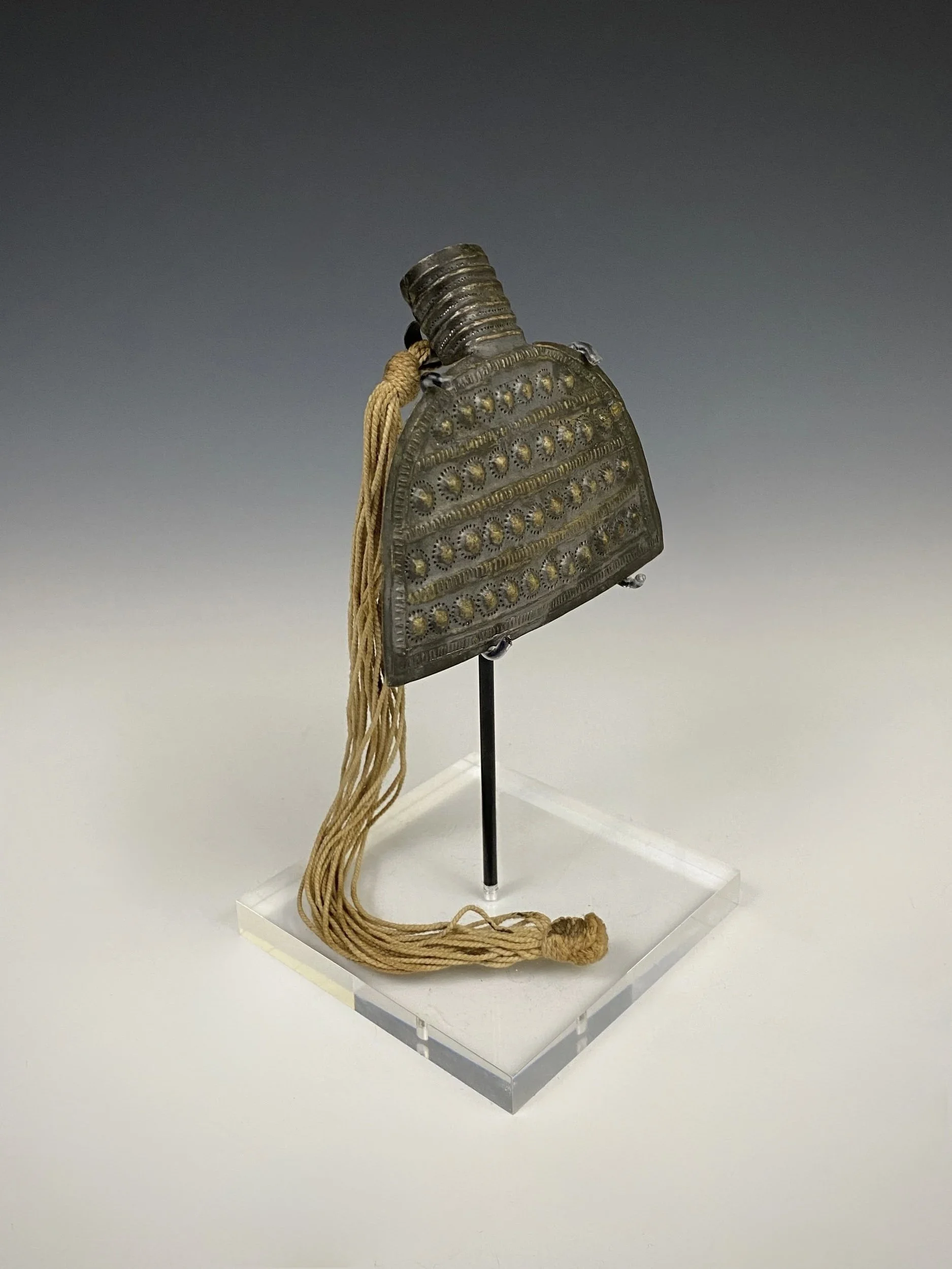 Asante Amulet in the form of a Hoe or “daba”. Ghana. Silver, fiber. H 9 cm. Additional notes: The fiber is similar to the pineapple fiber used with Akrafokonmu” or “soul washer’s” disc pectorals. Estate of René David (1928-2015), Zurich. Exhibited: M