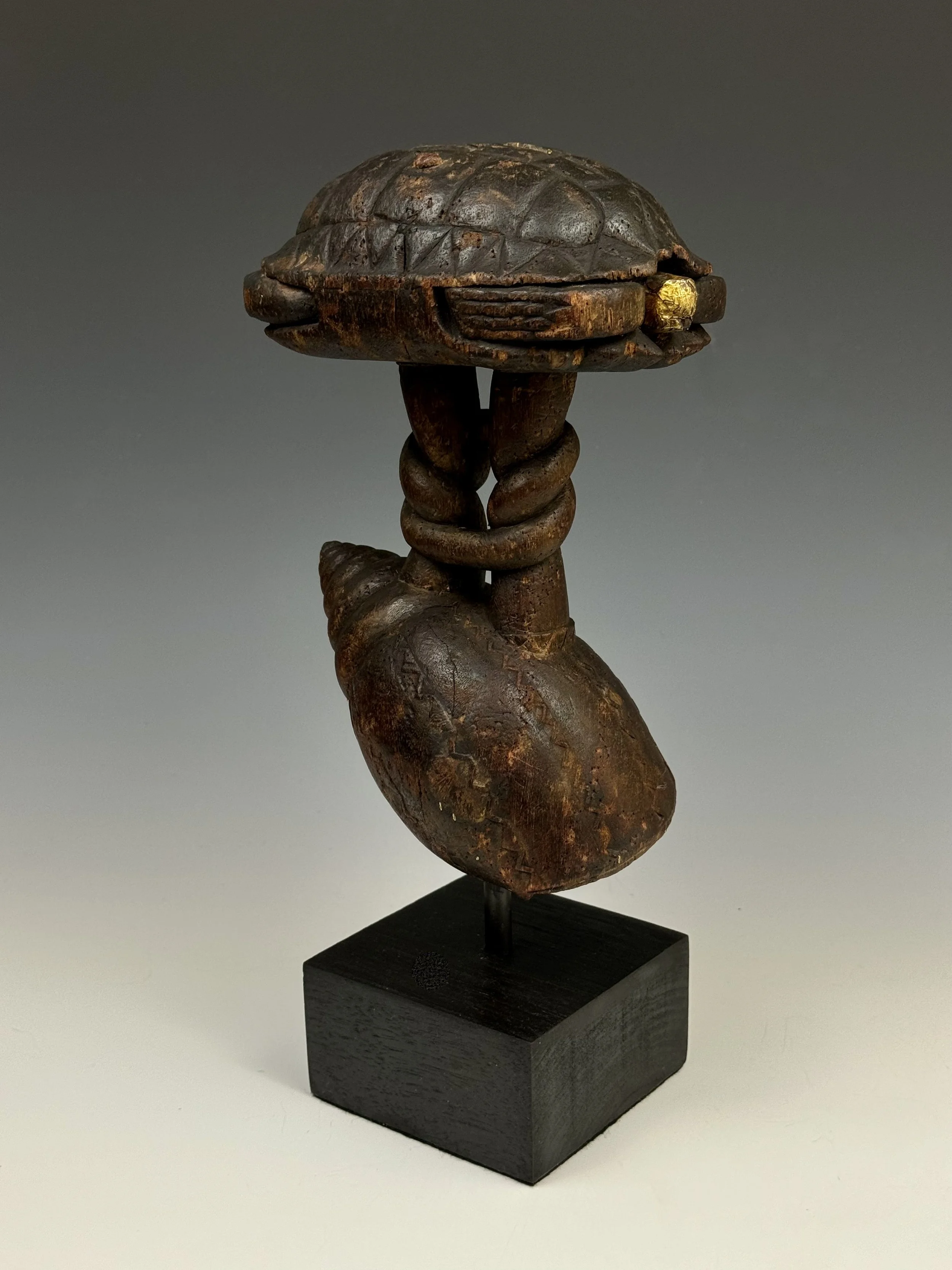 Akan state swords like this one are more ceremonial and symbolic of an instrument of power and are always carried by the “blade”. The sword blade here depicts imagery of wisdom knots, crocodiles, and other Akan symbols. The sculptural hilt is a highl