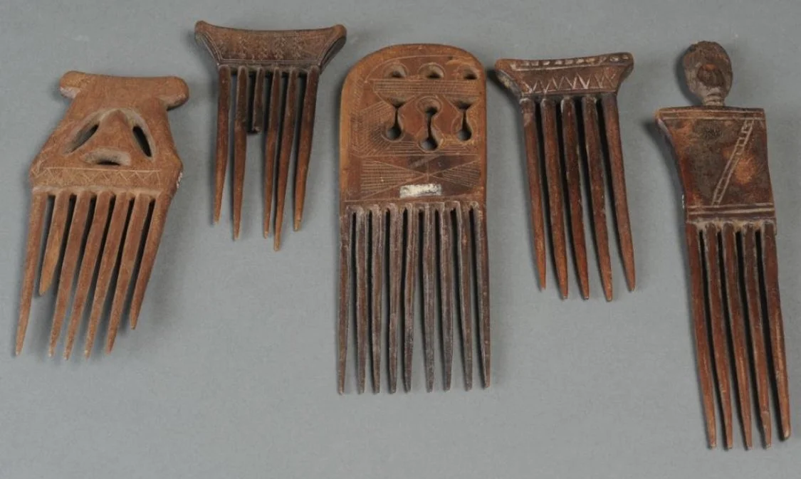 Five carved wood combs. Asante, Ghana. Largest approx. 9" L. Some damaged sections with old collection inventory markings. Estate of Thomas McNemar, (1931-2020.) McNemar lived and collected throughout Central and West Africa in the 1960s and 70s. He