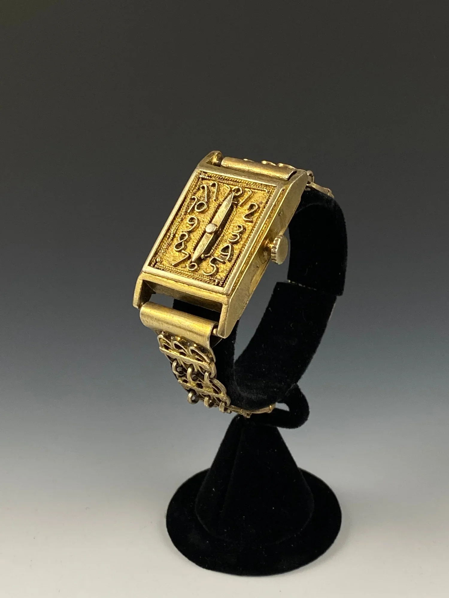 Asante chief’s bracelet. “You have watches, we have time”- Akan proverb. Gilded Silver alloy. This mimics a western watch and reflects the power and authority of the ruler, who can control time. Non functional- worn as a symbol of the message and sta