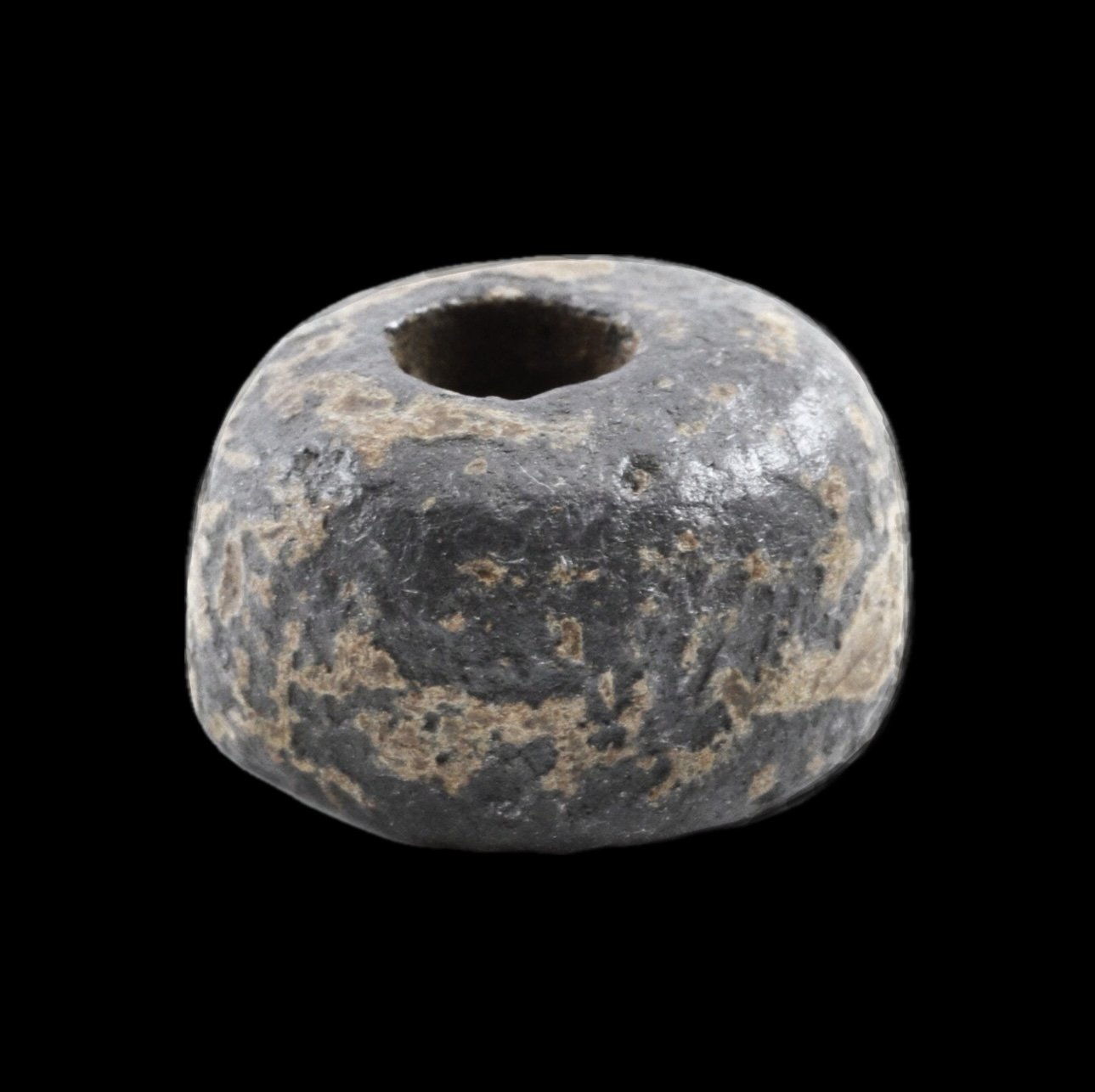 An Akan gold weight with a center hole.  This weight has a heavily aged patina and shows signs of its age and use. 
Ex Sir Cecil Armitage Collection. Dating to the second half of the 19th century to early 20th. Sir Cecil Armitage, Governor of Gambia 