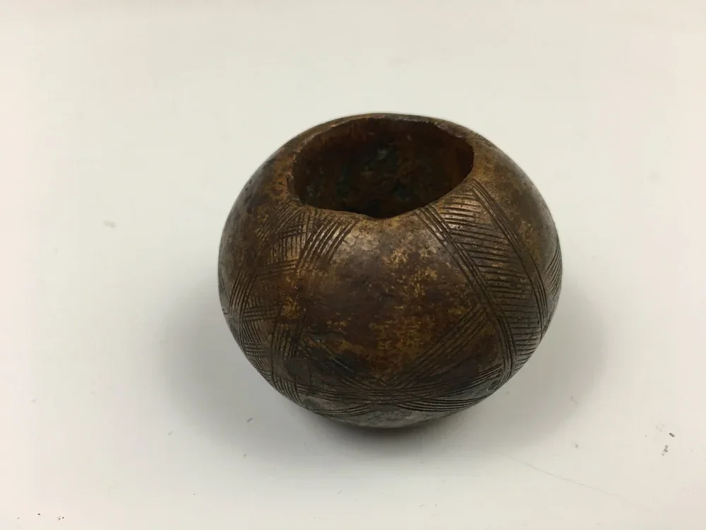 A large incised copper alloy ring collected in Mali, possibly Fulani.