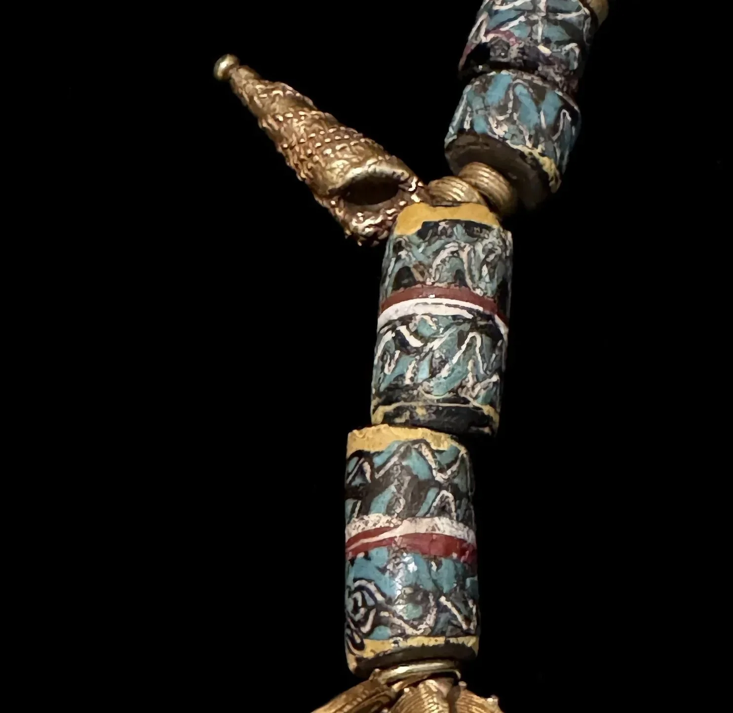 An exceptional Akan necklace from Ghana/ Côte D’Ivoire consisting of gold beads (10K-18K) with a downward pointing gold alloy crescent moon shaped pendant. Rare large glass Venetian cylindrical beads (1850-1920) alternate with the gold beads. The maj