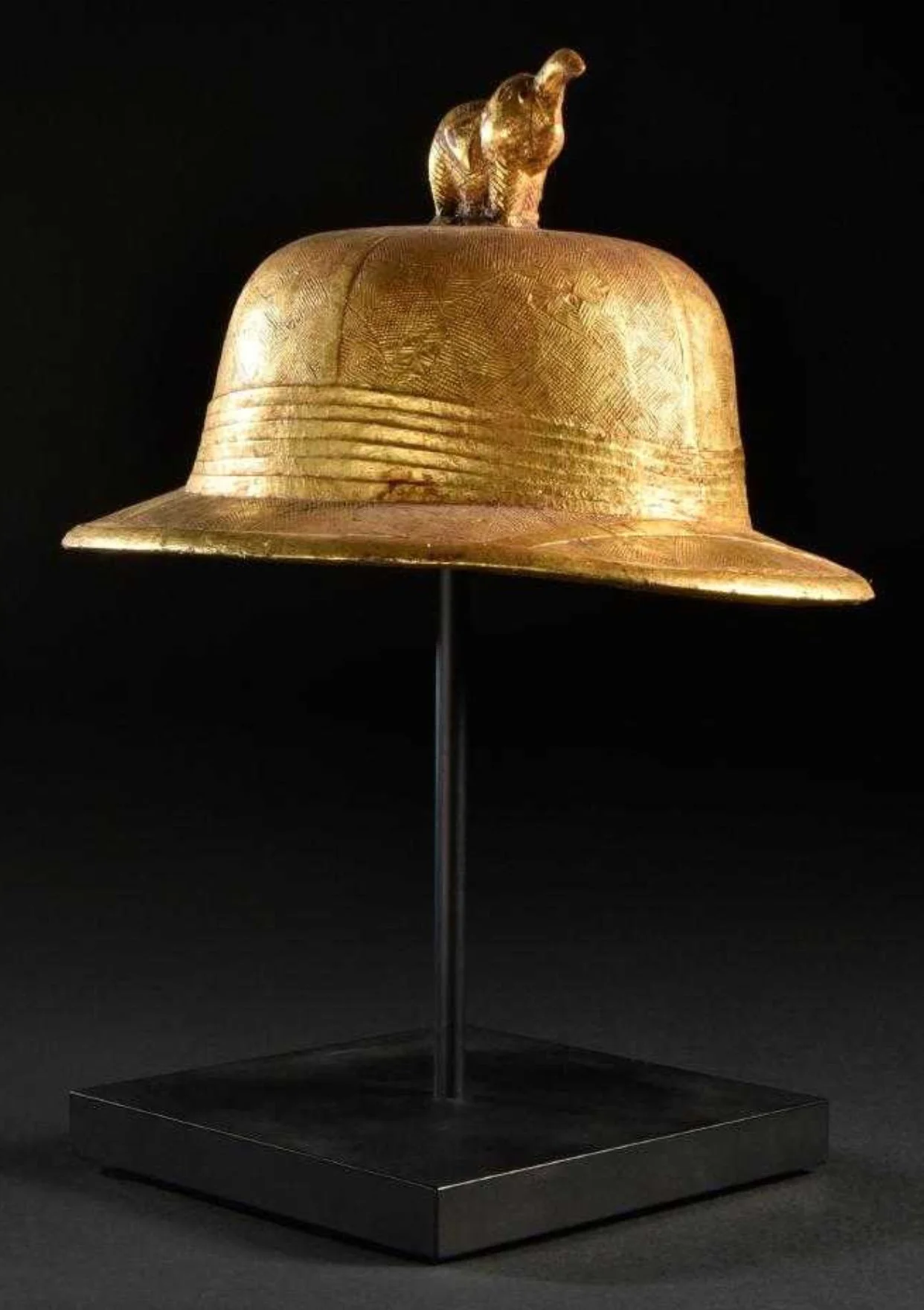 Two of my favorite Baule items in the collection are skeuomorphs, objects in the same shapes as the originals, yet carefully carved from wood with intricate surface designs. Gold leaf covers the pith helmets, an indication that they were display obje