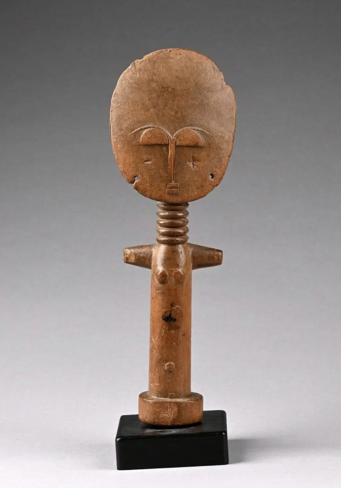 An Akan (Asante) “Akuaba” fertility figure, Ghana. Wood, 9.4” H (24cm). “The name Akuaba comes from the legend of a woman named Akua who was distraught at being barren, for Akan women desire above all to have children. She took her problem to a pries