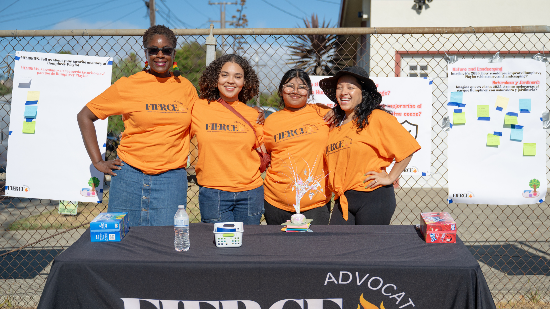 FIERCE Advocates staff members smiling together at an outdoor community event.
