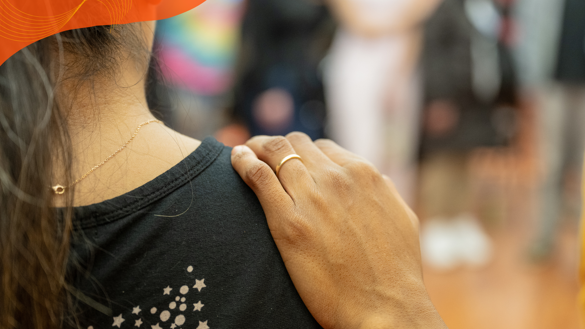 A supportive hand rests on a participant’s shoulder during a FIERCE Advocates community gathering.