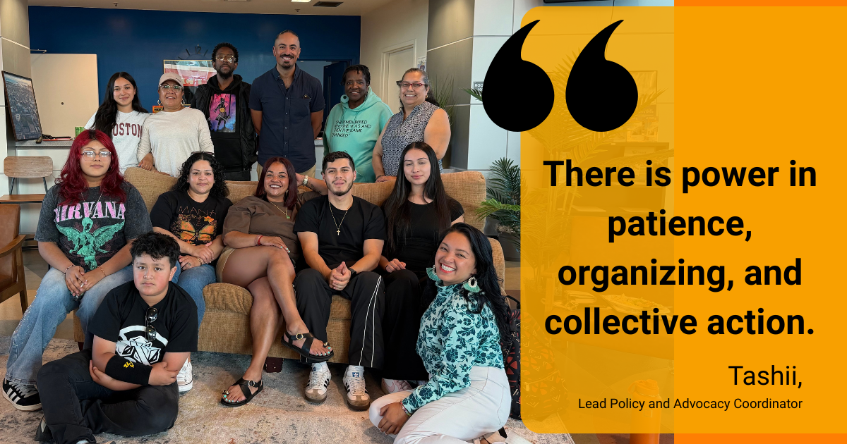Resident Organizing Training participants pose for a group photo with Tashii’s quote, “There is power in patience, organizing, and collective action.”