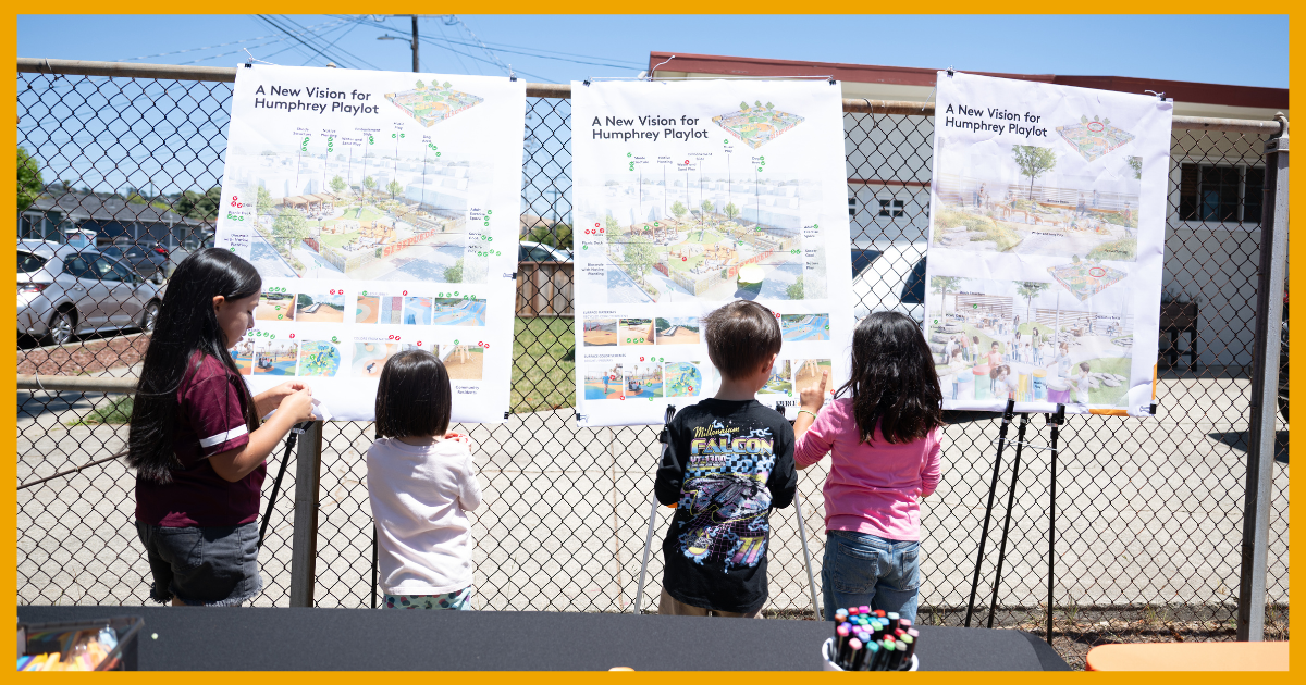 children gather around the Humphrey Playlot design plan during the June 2026 Summer Block Party in Richmond.
