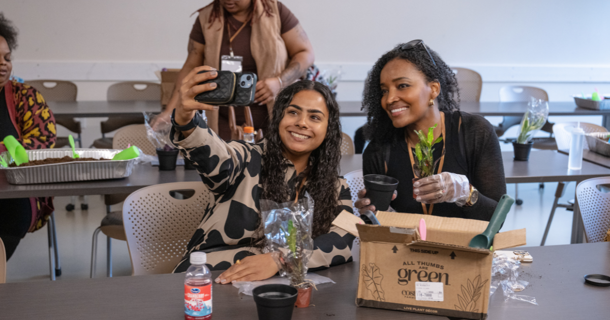 2 participants take a selfie during the planting session
