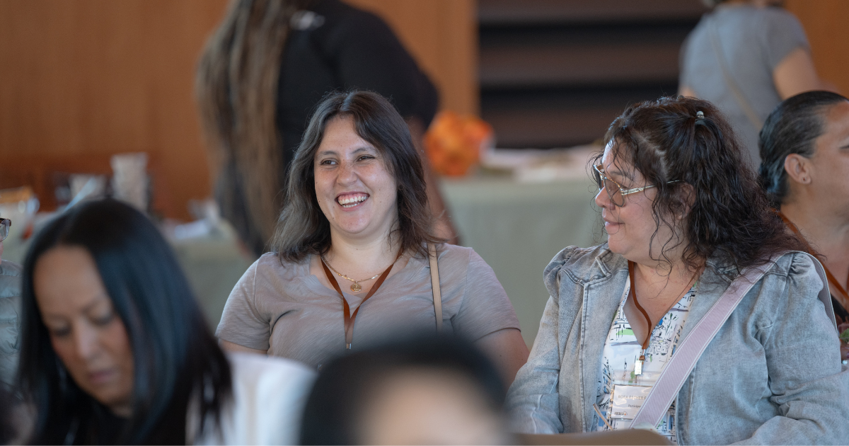 Participants connect and share conversation while seated together at the Latina Sanctuary Conference.
