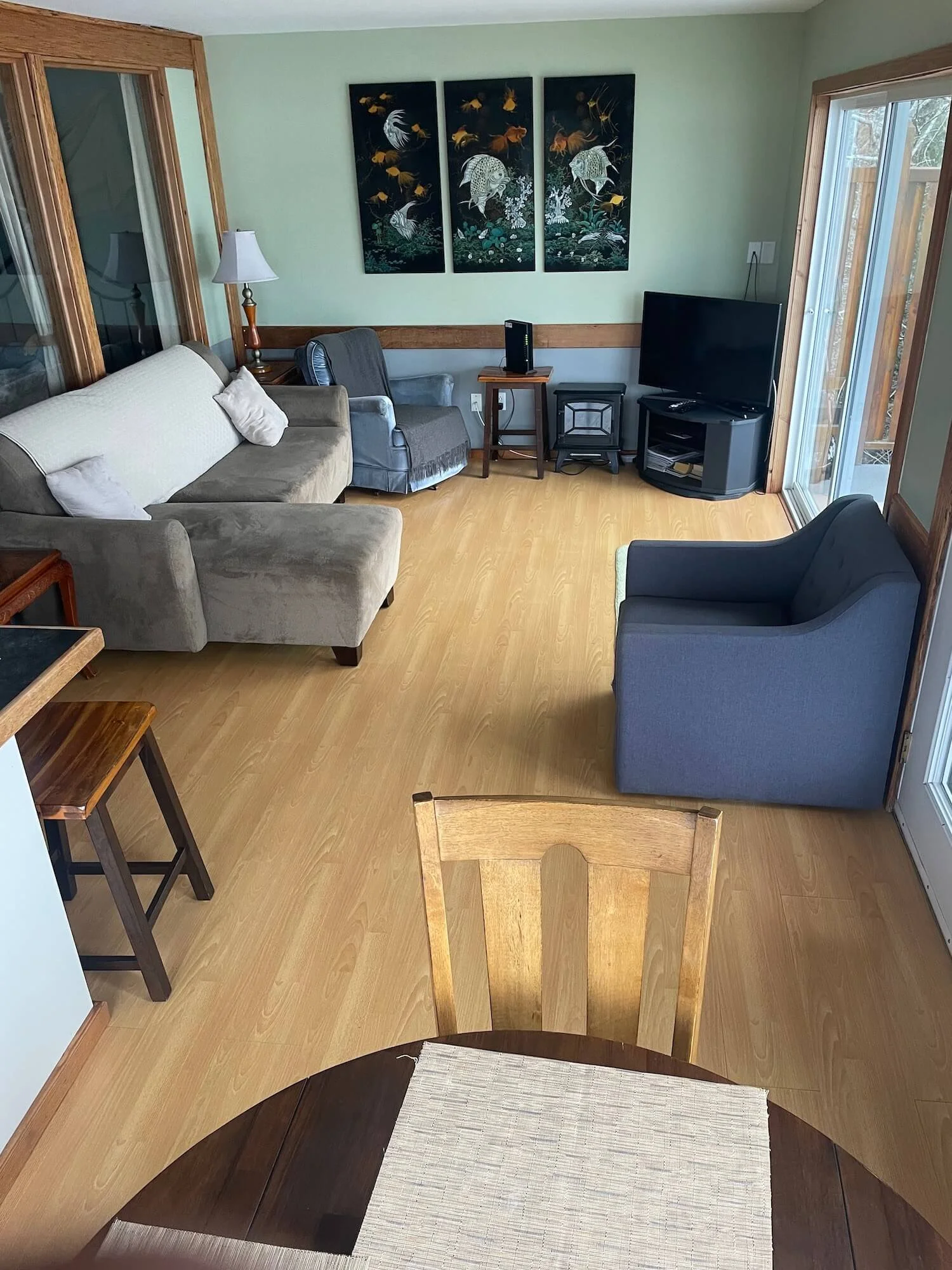 Living room wth art on the walls and bright window
