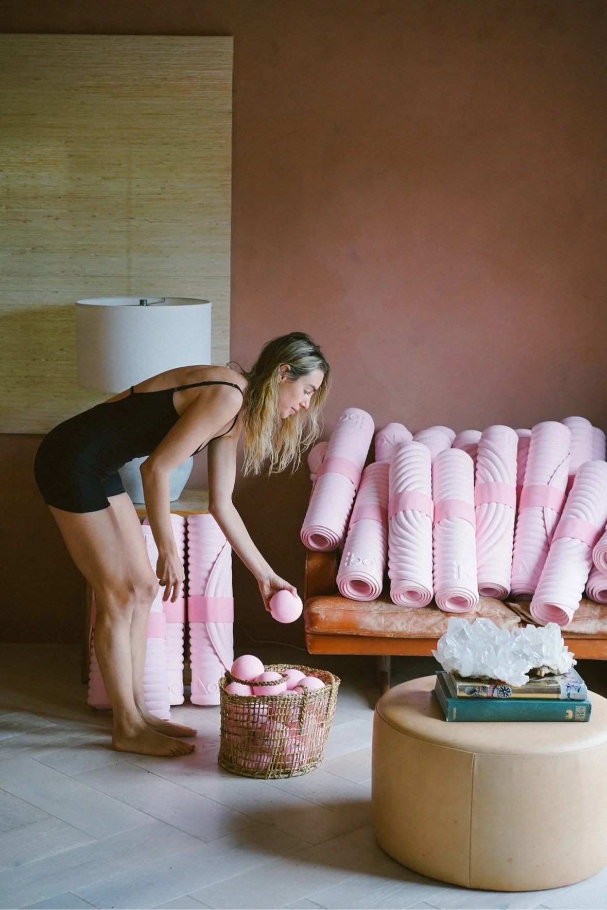 Jessie preparing pink yoga mats for a session