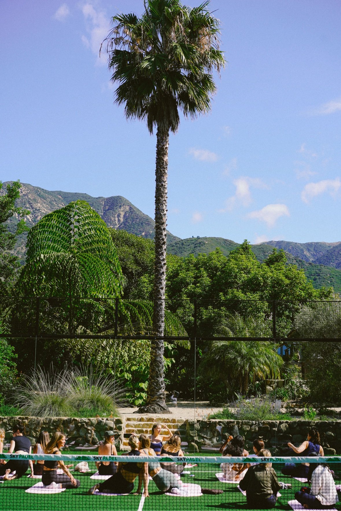 Group session on a padel court beneath the mountains