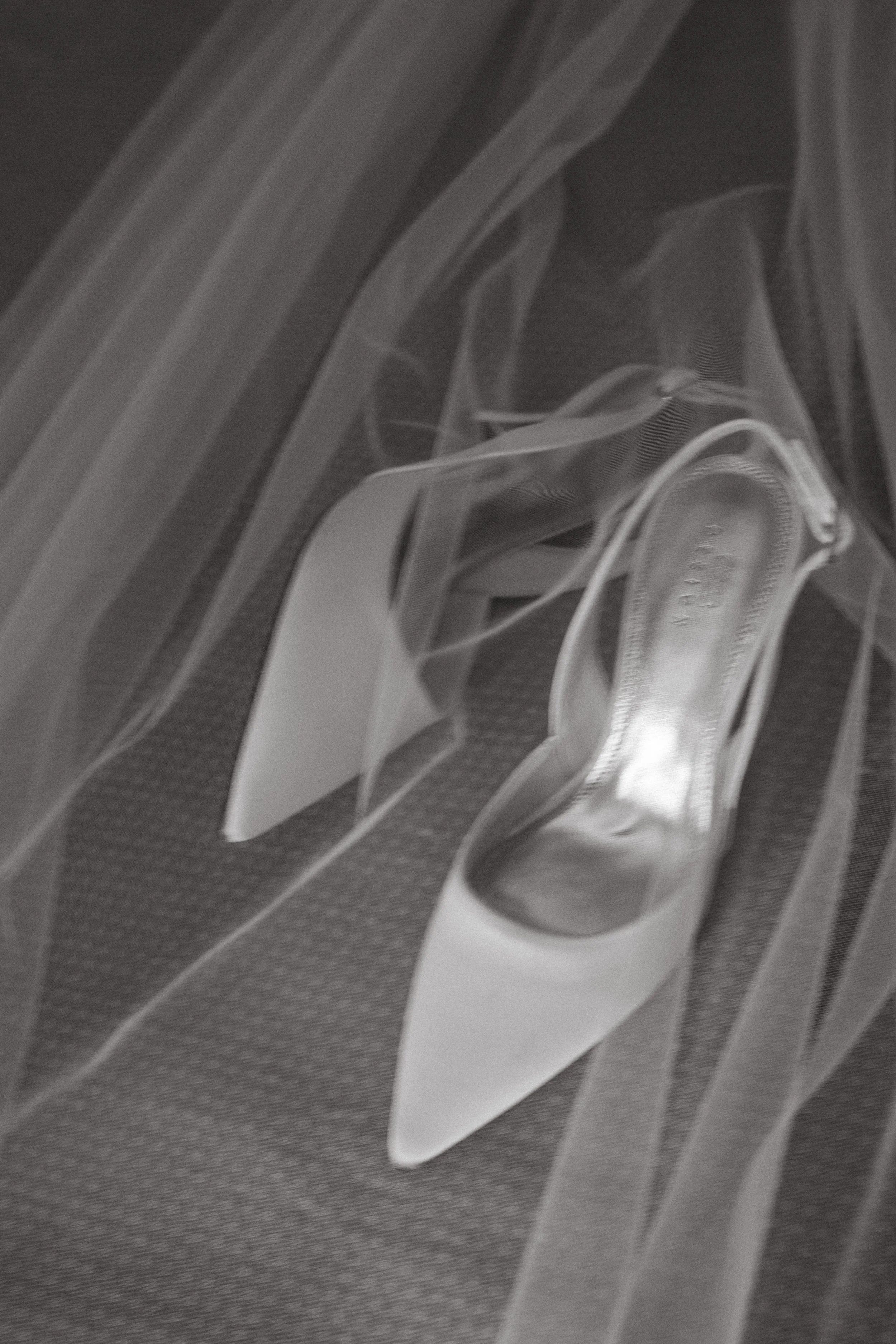 X-ray image of a high-heeled shoe, showing metallic and transparent components.