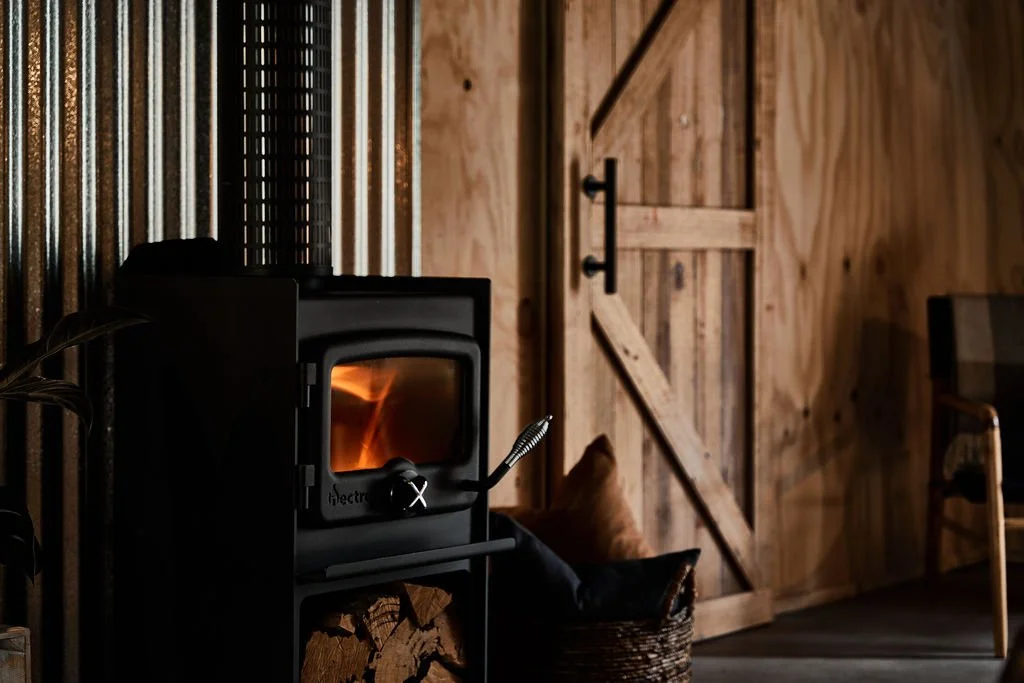 The fireplace is lit in the Shepherds Hill Shearers Quarters