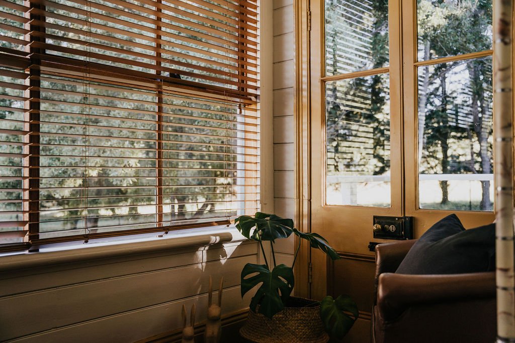 An armchair in the Shepherds Hill Cottage sunroom is bathed in natural light