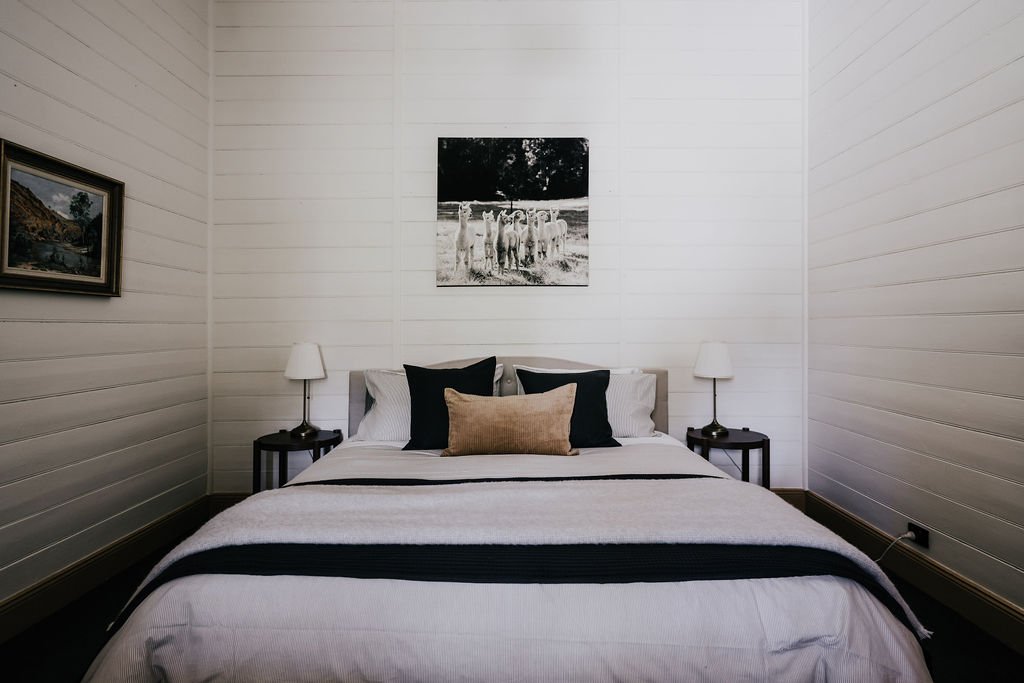 Main_bedroom_with_king-sized_bed_adorned_with_alpaca_wool_bedding_at_Shepherds_Hill_Cottage.jpg