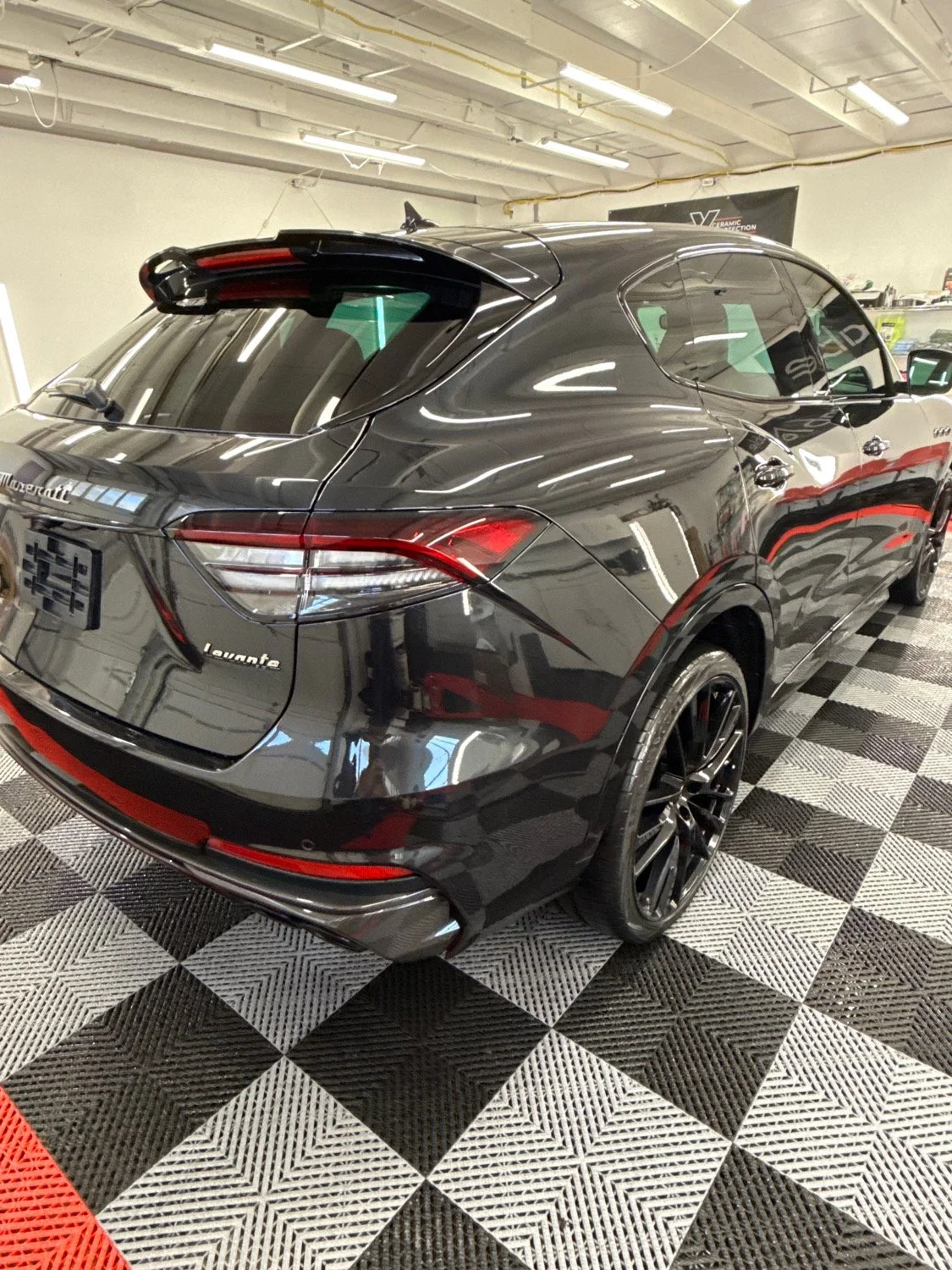Dark luxury SUV with monthly membership maintenance and ceramic coating protection