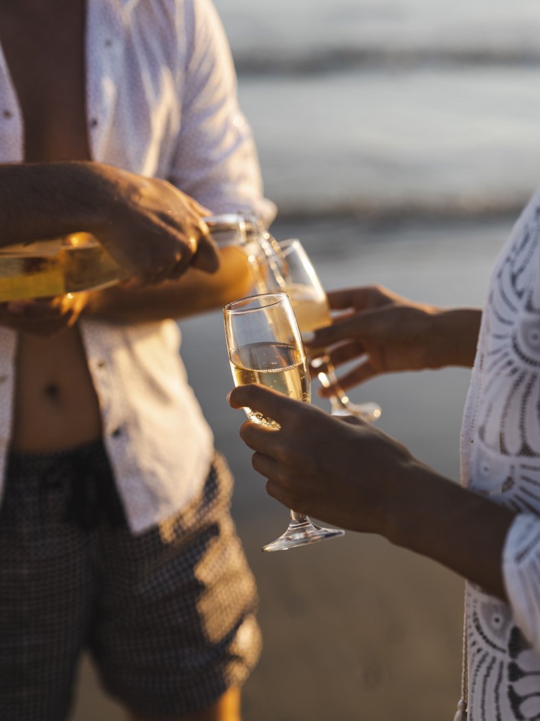 honeymoon-couple-drinking-champagne-tropical-beach-west-point-sunset-tour.JPG