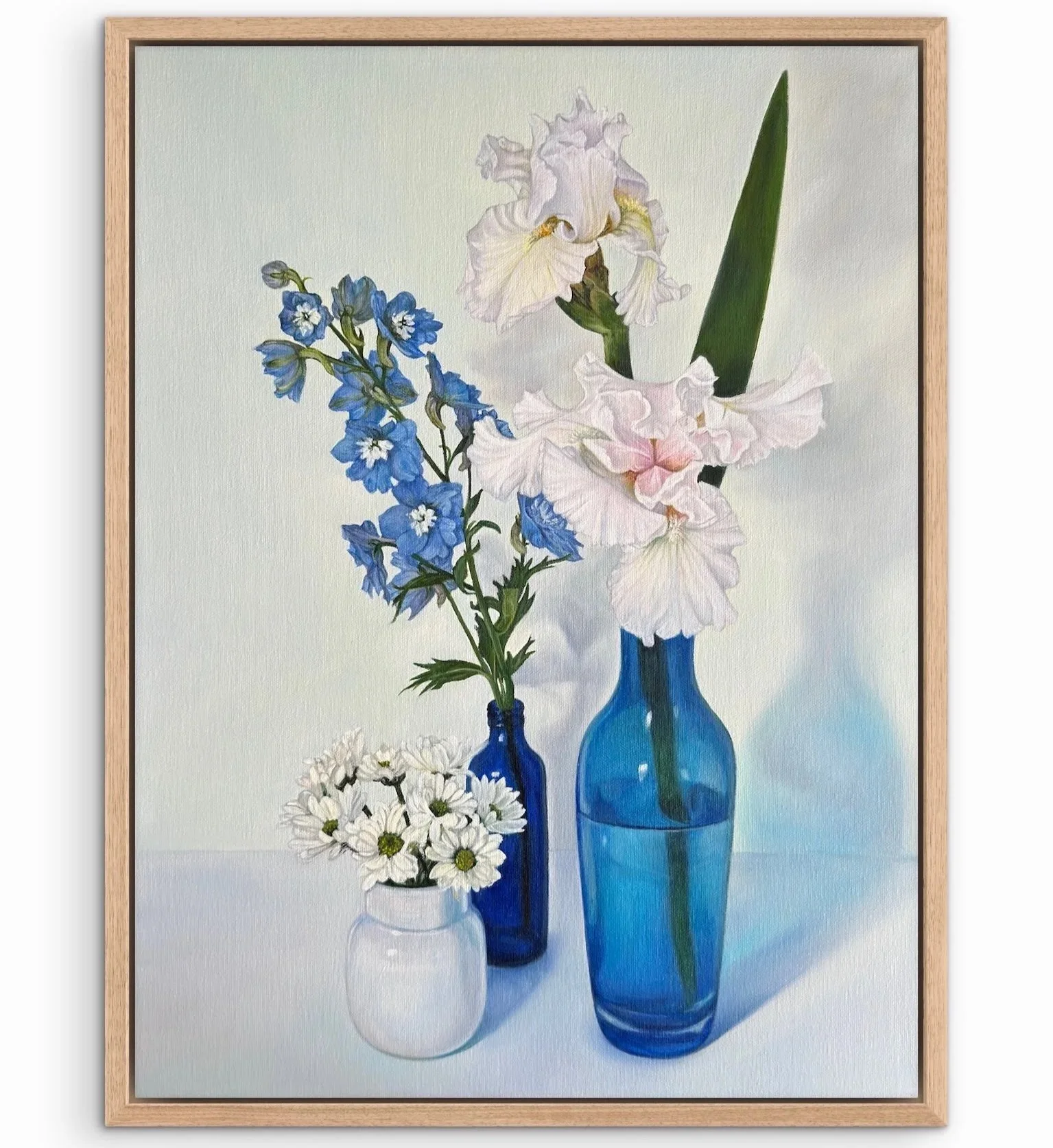 oil painting in wood frame o blue and white flowers in blue and white glass vases