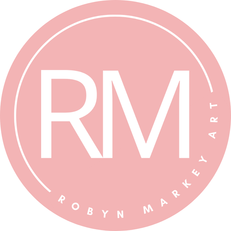 Pink circular logo with white letters "RM" in the center and the text "ROBYN MARKEY ART" around the edge.
