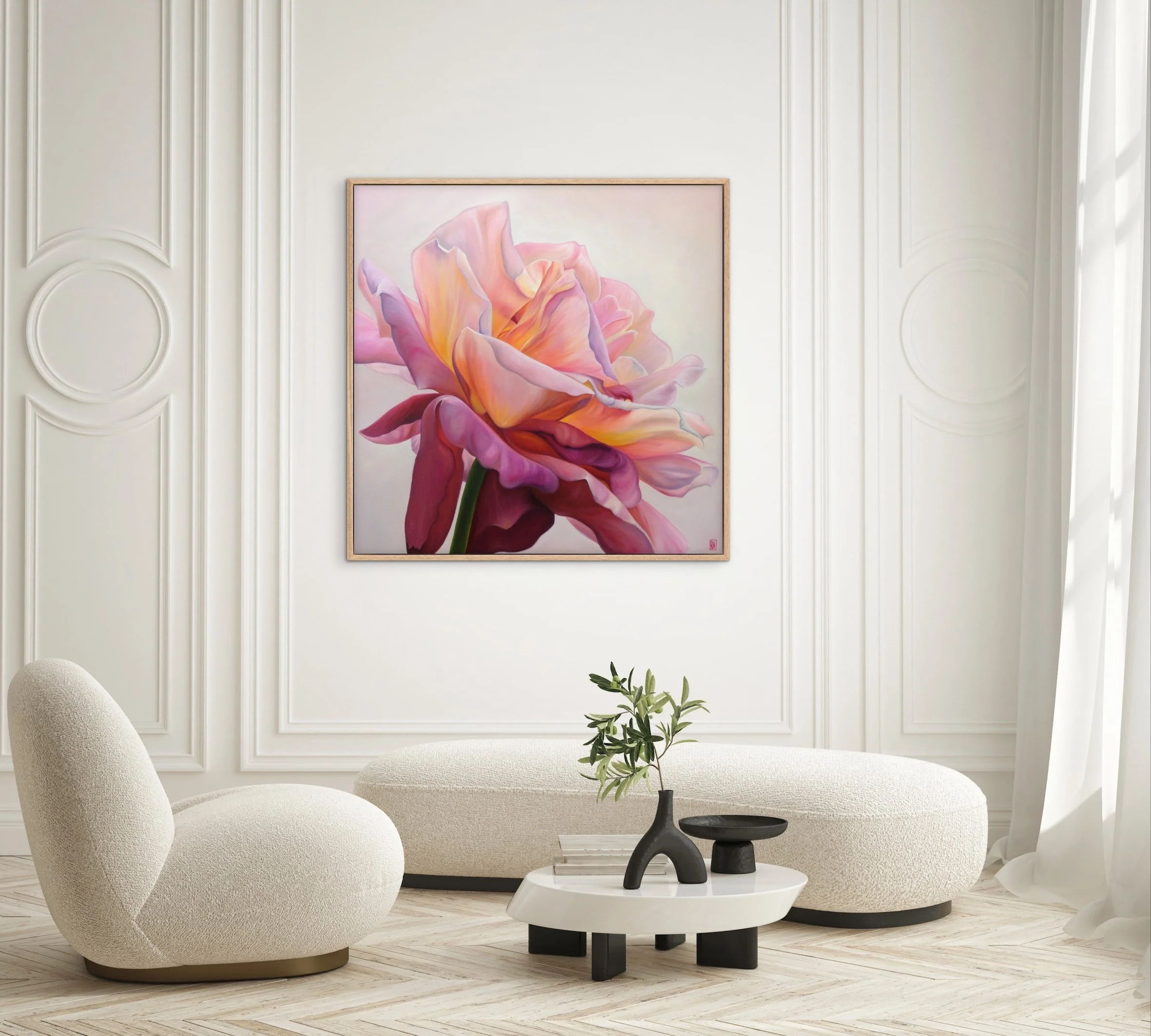 Modern living room with a large pink and peach flower painting by Robyn Markey on the white wall, minimalist white chairs, a small white table with black decorations, and a plant, with natural light from the right side.