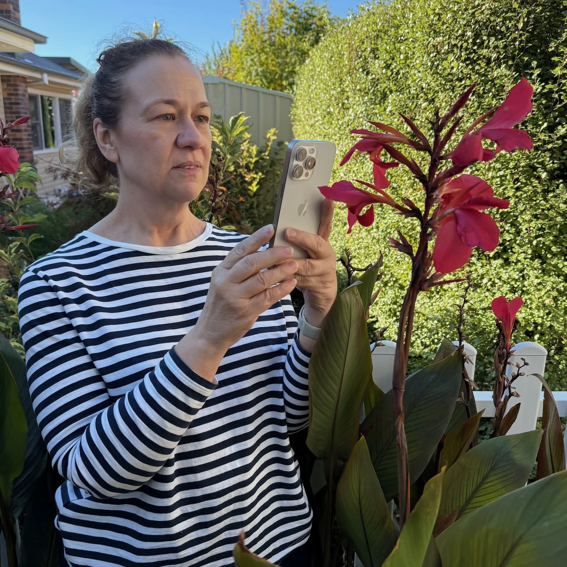 Robyn Markey photographing flowers in her garden