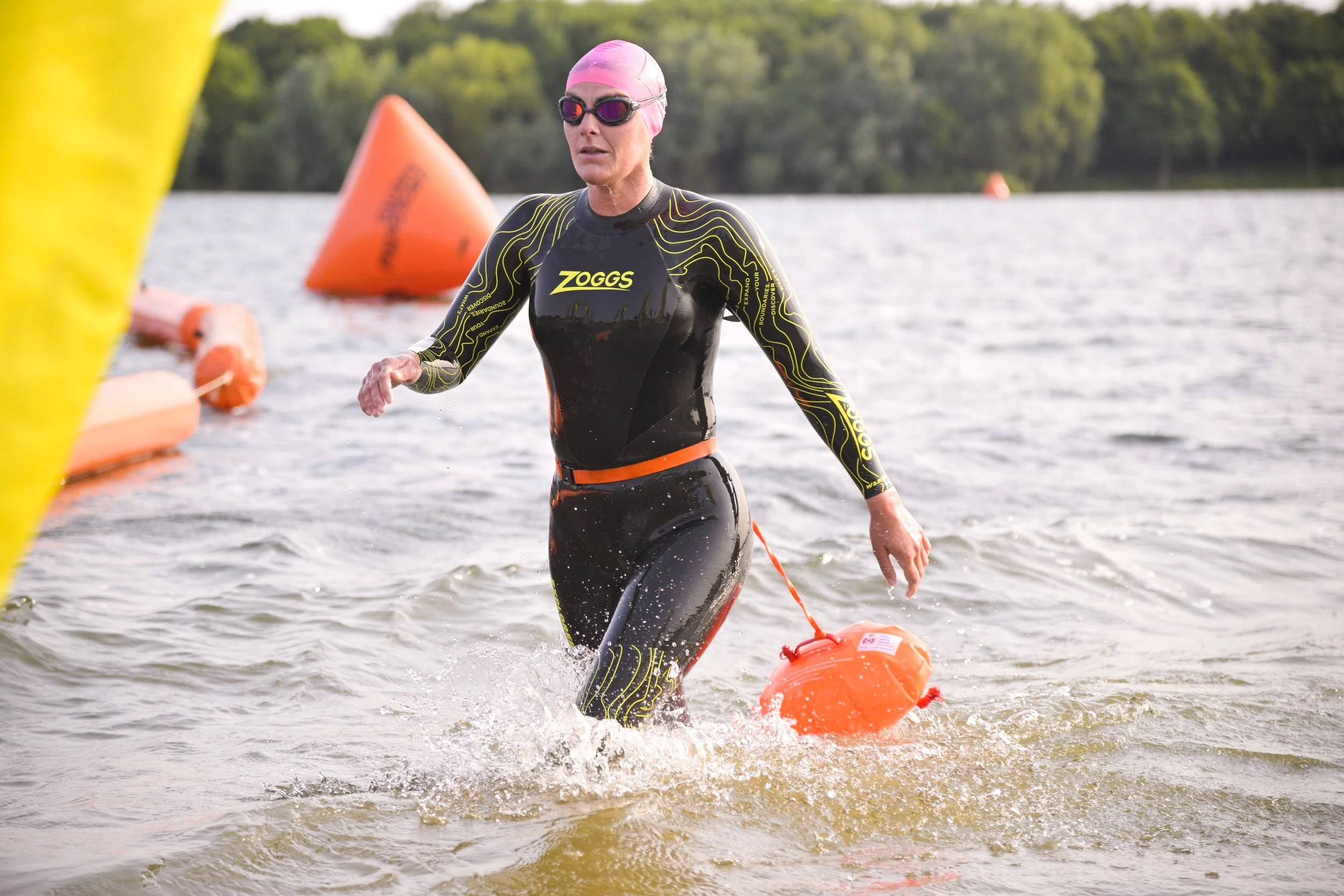 Laura running out of water after completing a 10K open water swim at Alton Water Lake