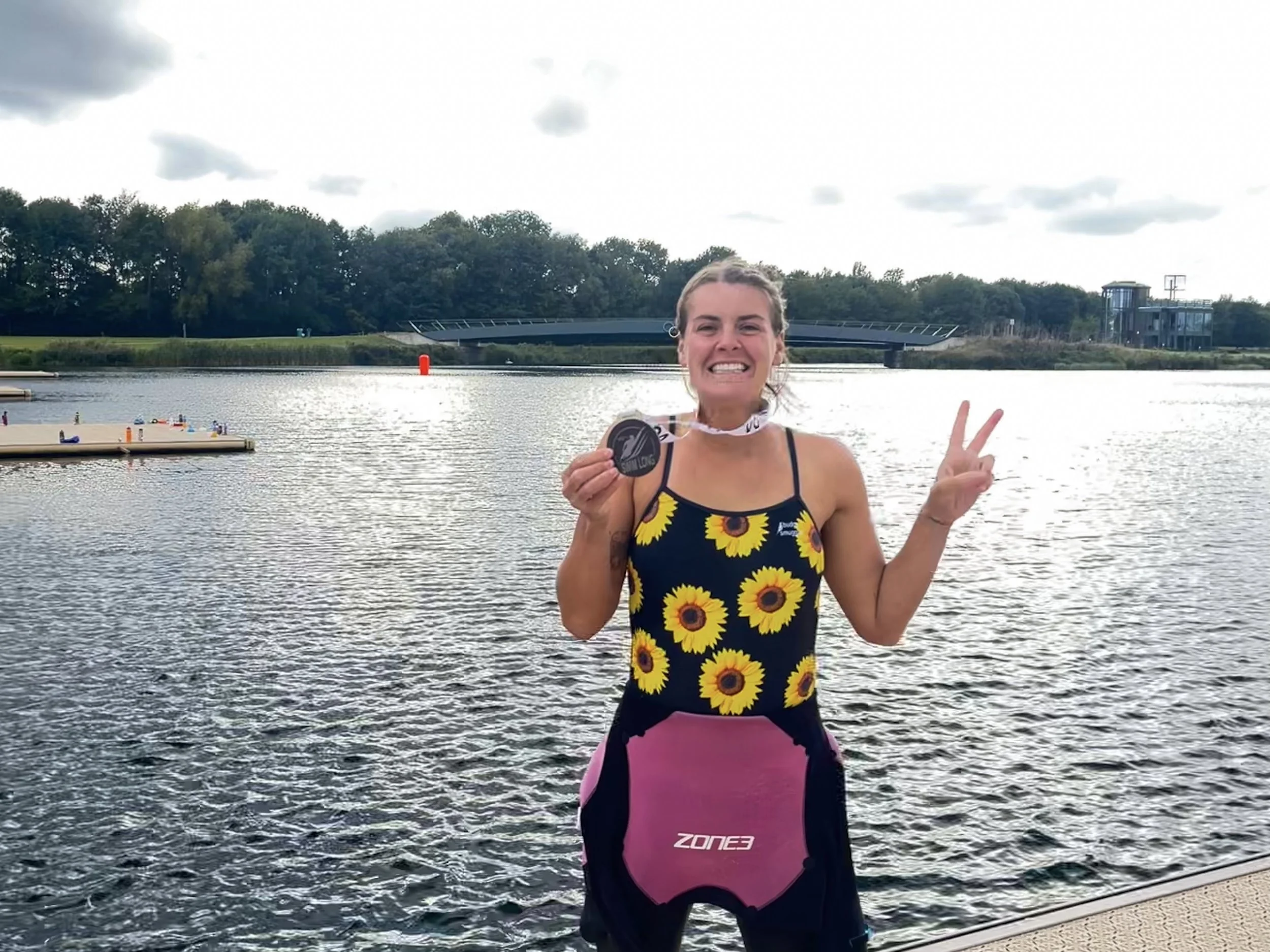 Laura celebrating a personal best after a 10K swim at Dorney Lake