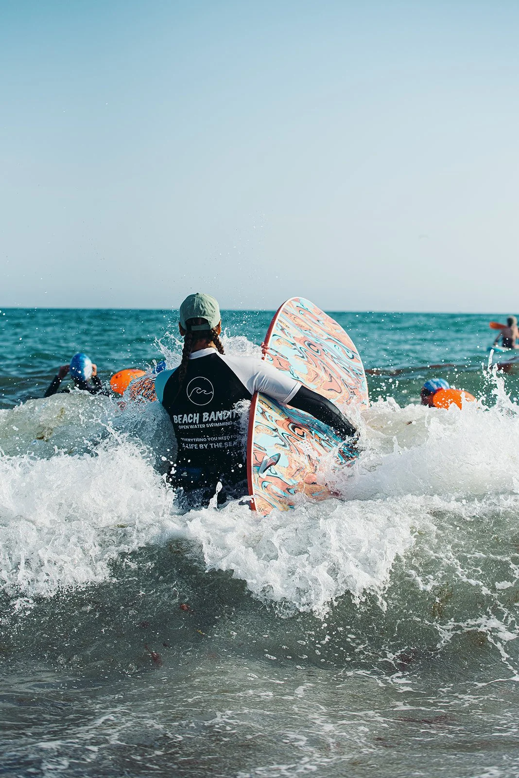 Beach Bandit Swimming instructor crashing through waves on surfboard