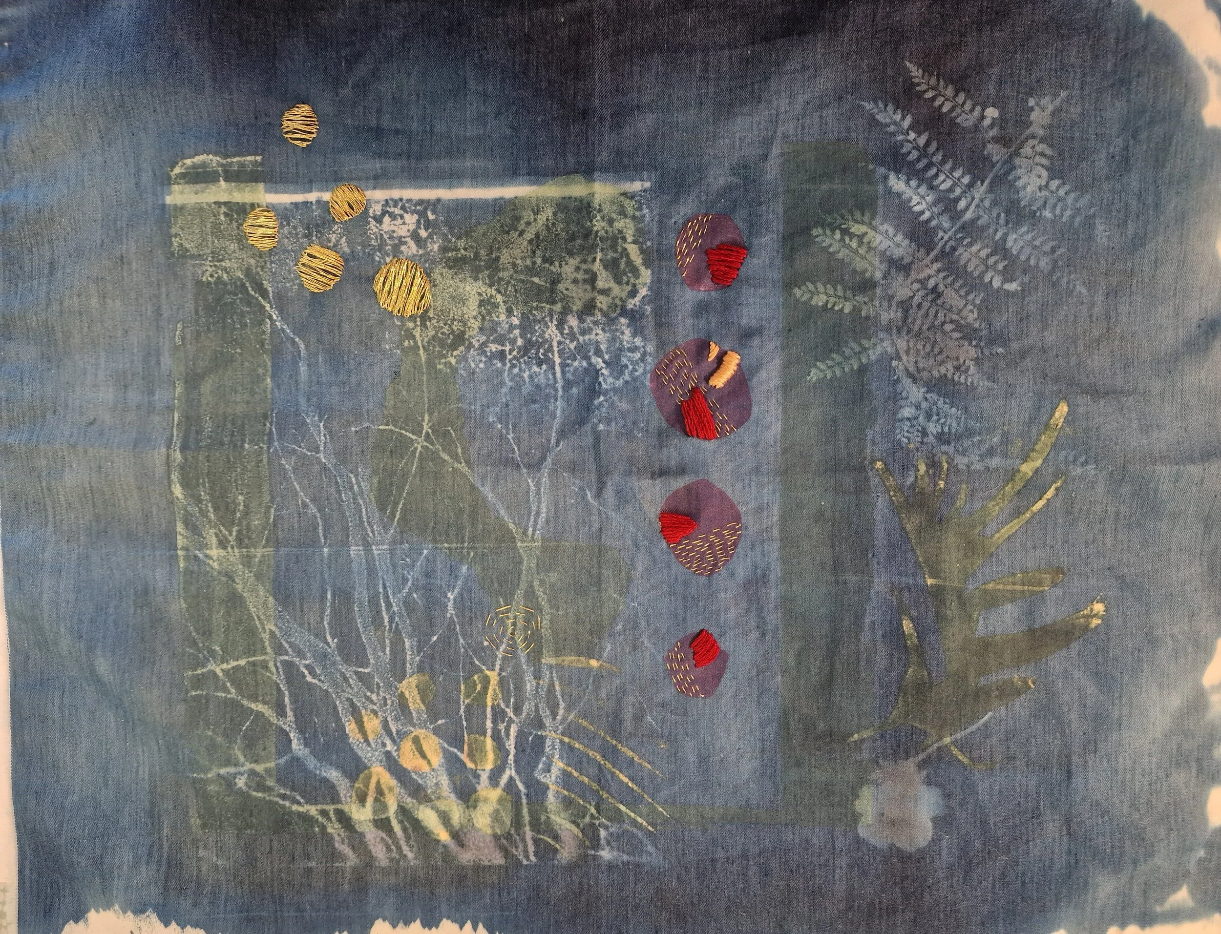 Dust spot 
cyanotype on cotton, screen print, cotton thread, gold thread.
Cyanotype print using ferns and acetate photograph on cotton fabric. Shapes taken from sketches screen printed in background. Dots emphasised with hand stitch using cotton and 