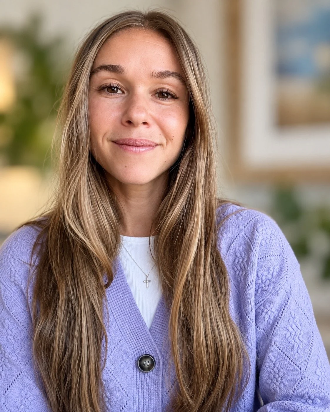 Rachael Martin at Sunergos Counseling Collective wearing glasses and shoulder-length hair smiling in an indoor setting with blurred background.