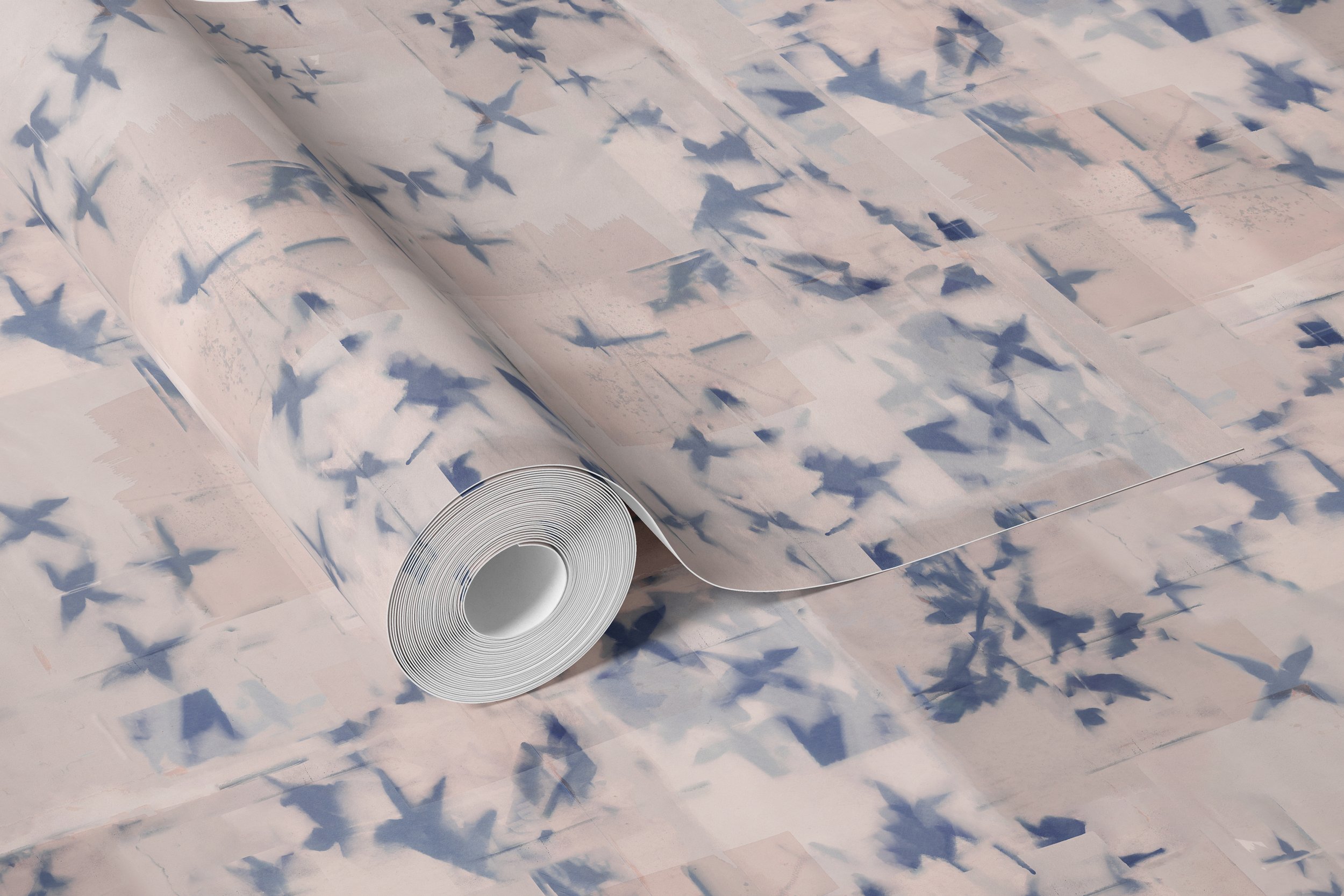 A roll of wall paper with a pattern of abstract leaves in silhouette against a textured beige background.